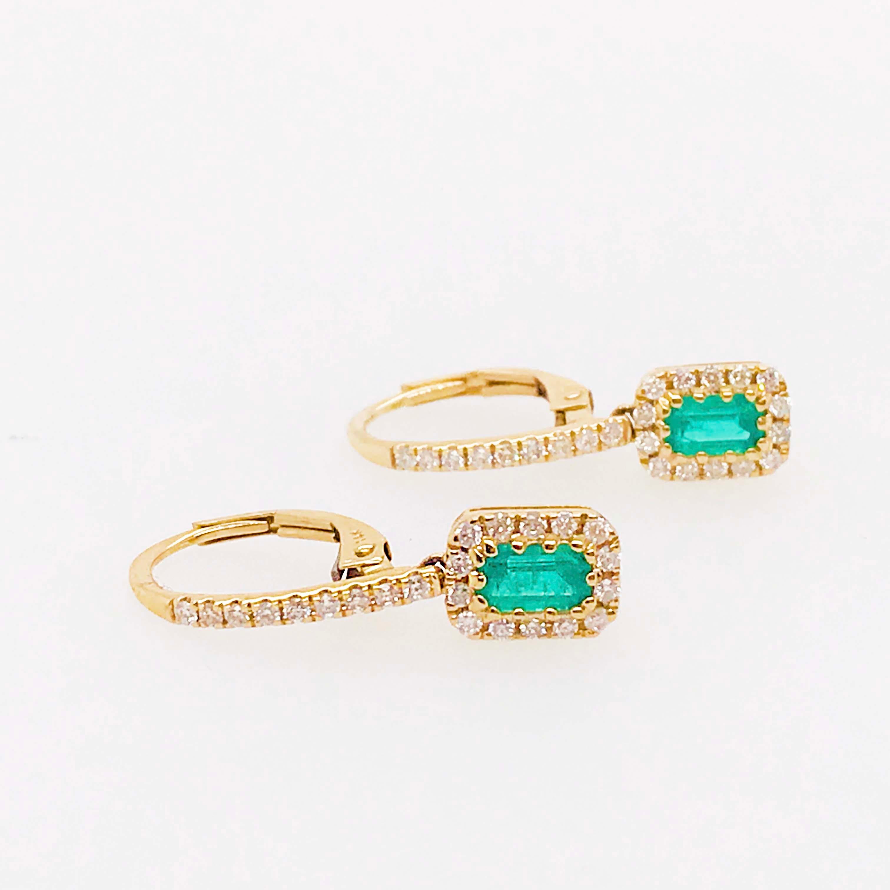 The gorgeous 14 karat yellow gold, genuine emerald, and diamond earring dangles are so special and stunning! With a natural emerald gemstone set in each earring. The emerald gemstones have been cut into emerald shapes. The emerald shape was designed