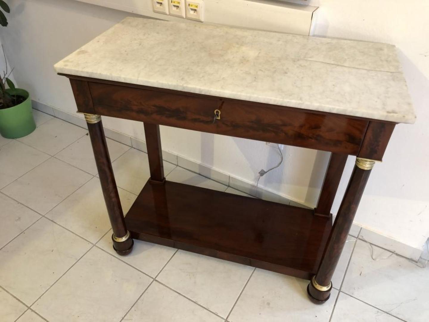 Original restored Empire console table from around 1800, restored to a perfect condition. 
Offers a stunning walnut wood build and perfect handcrafted quality.
This is a beautiful piece of nutwood, finished with shellac lacquer. Also features the