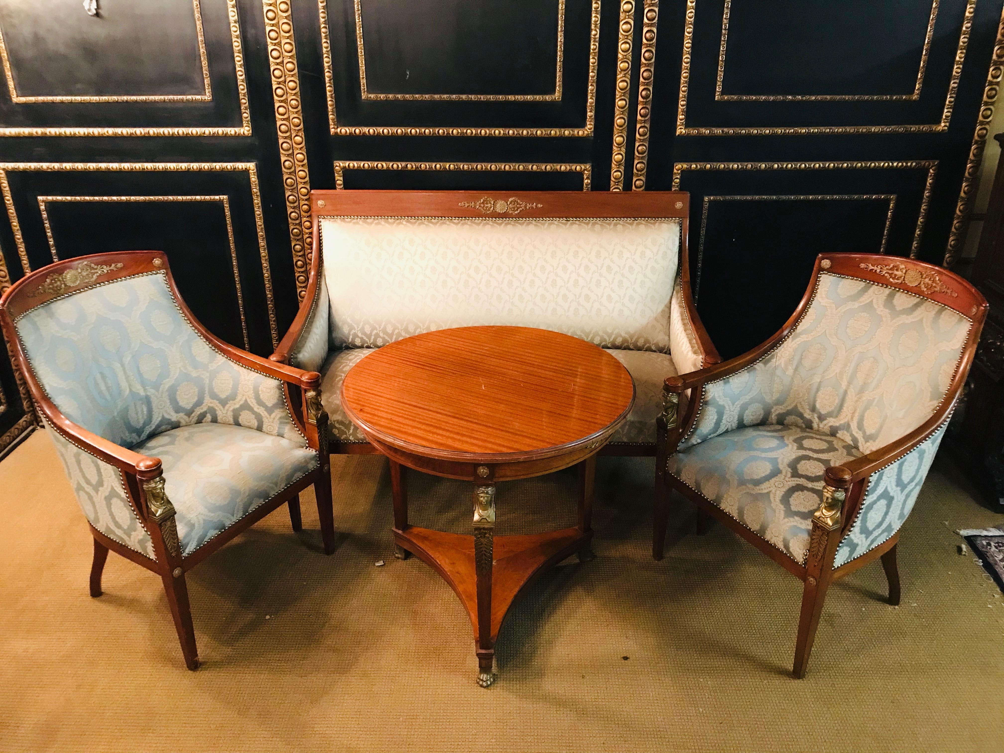 Original Empire sofa circa 1860-1870 from an Empire room.
Massive mahogany cast with Empire caryadites bronze.
The armchairs are made of a different fabric than the sofa and should be replaced
Top