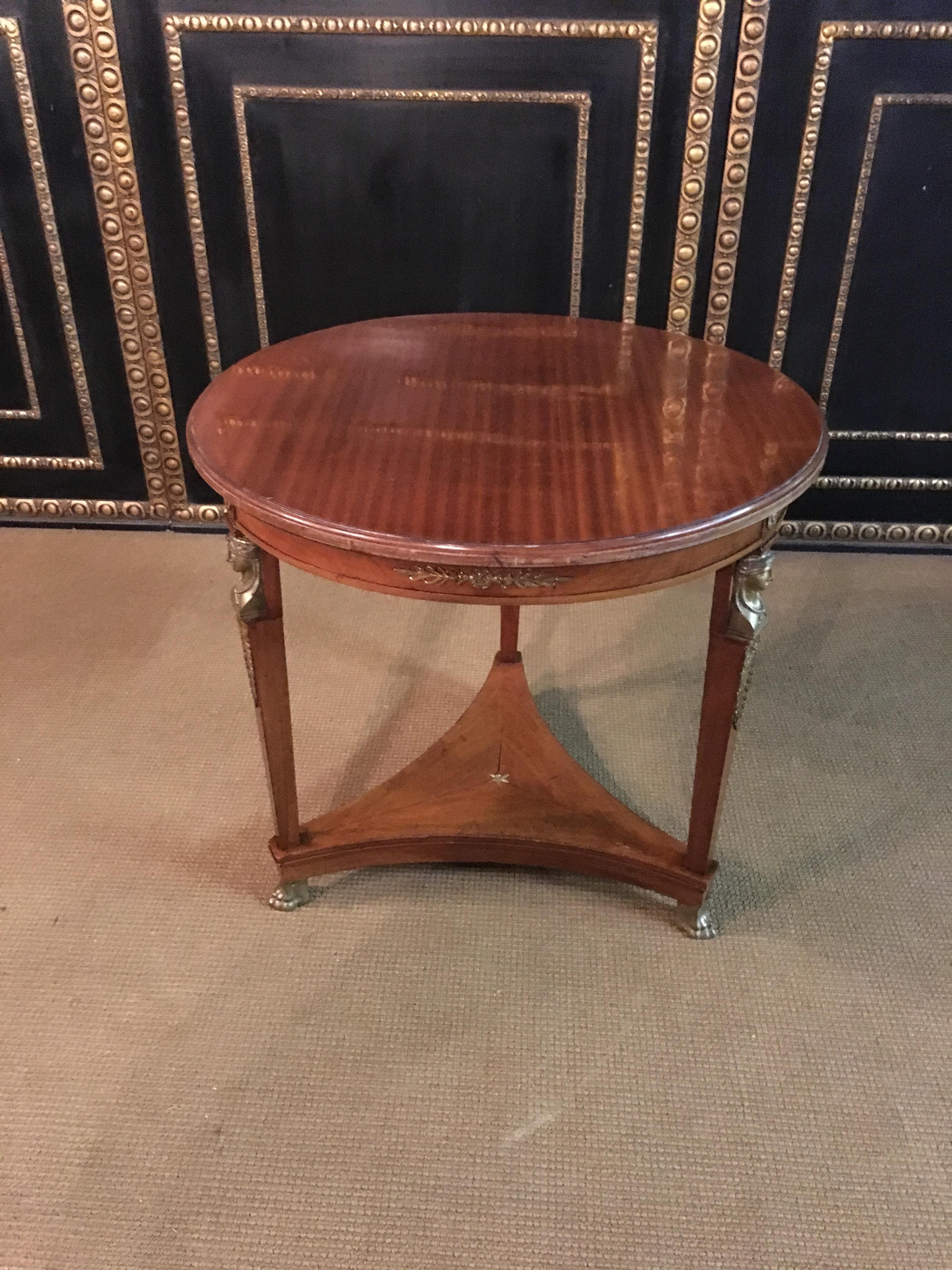 Original Empire table circa 1860-1870 from an Empire room.

The table stands on 3 feet of each foot 1 empire head cast in bronze.

Top condition.