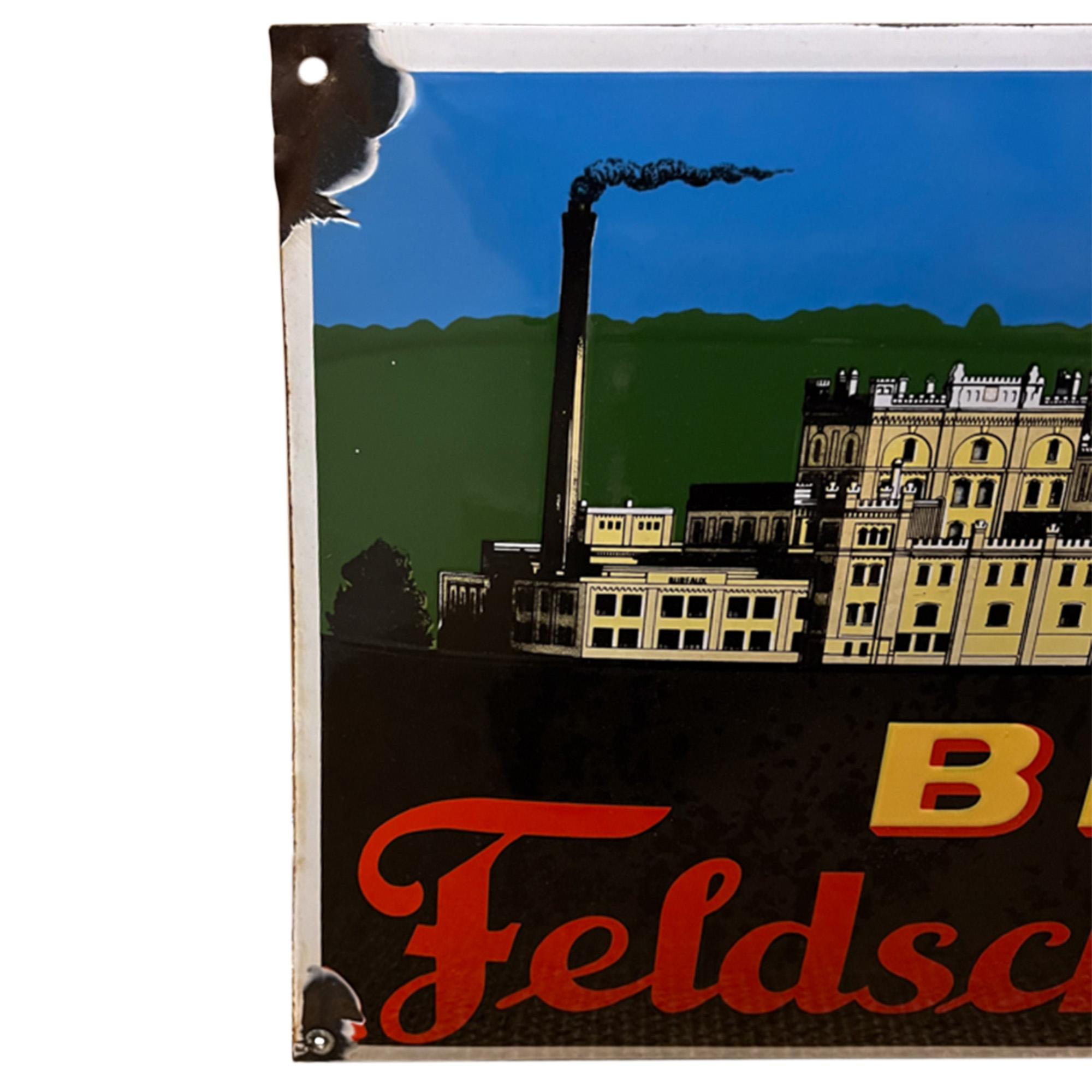 This is a beautiful enamel sign from the Swiss brewery of Feldschlösschen - which still operates today in the town of Rheinfelden on the Swiss/German border. 

Great colours and a very good likeness of their main building. Some wear, consistent with
