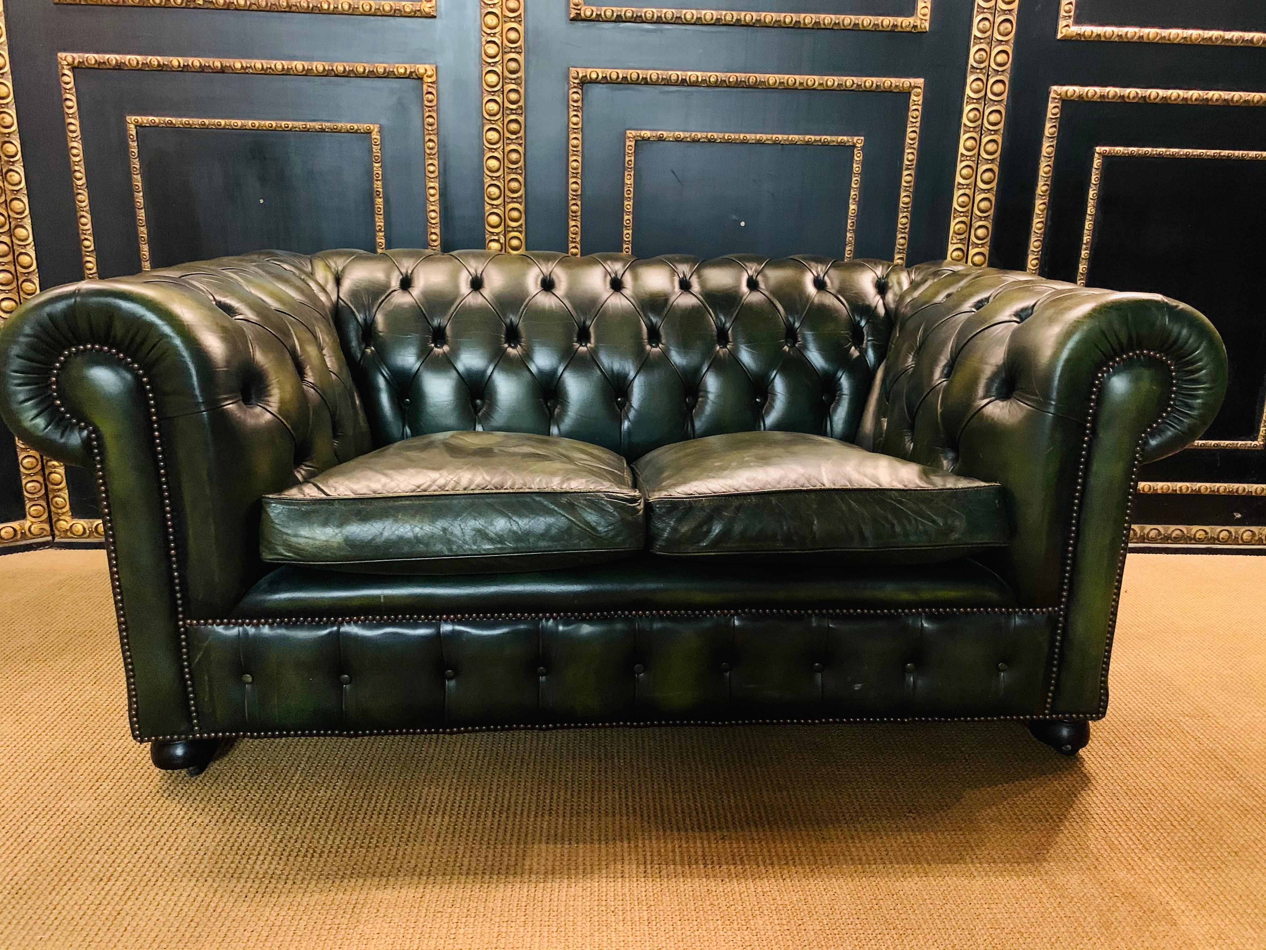 This original beautifully preserved Dark green leather small two-seat sofa is very masculine and small enough for an office. Coil sprung feather filled cushions - Vintage green leather Chesterfield sofa with original coil sprung front edge and