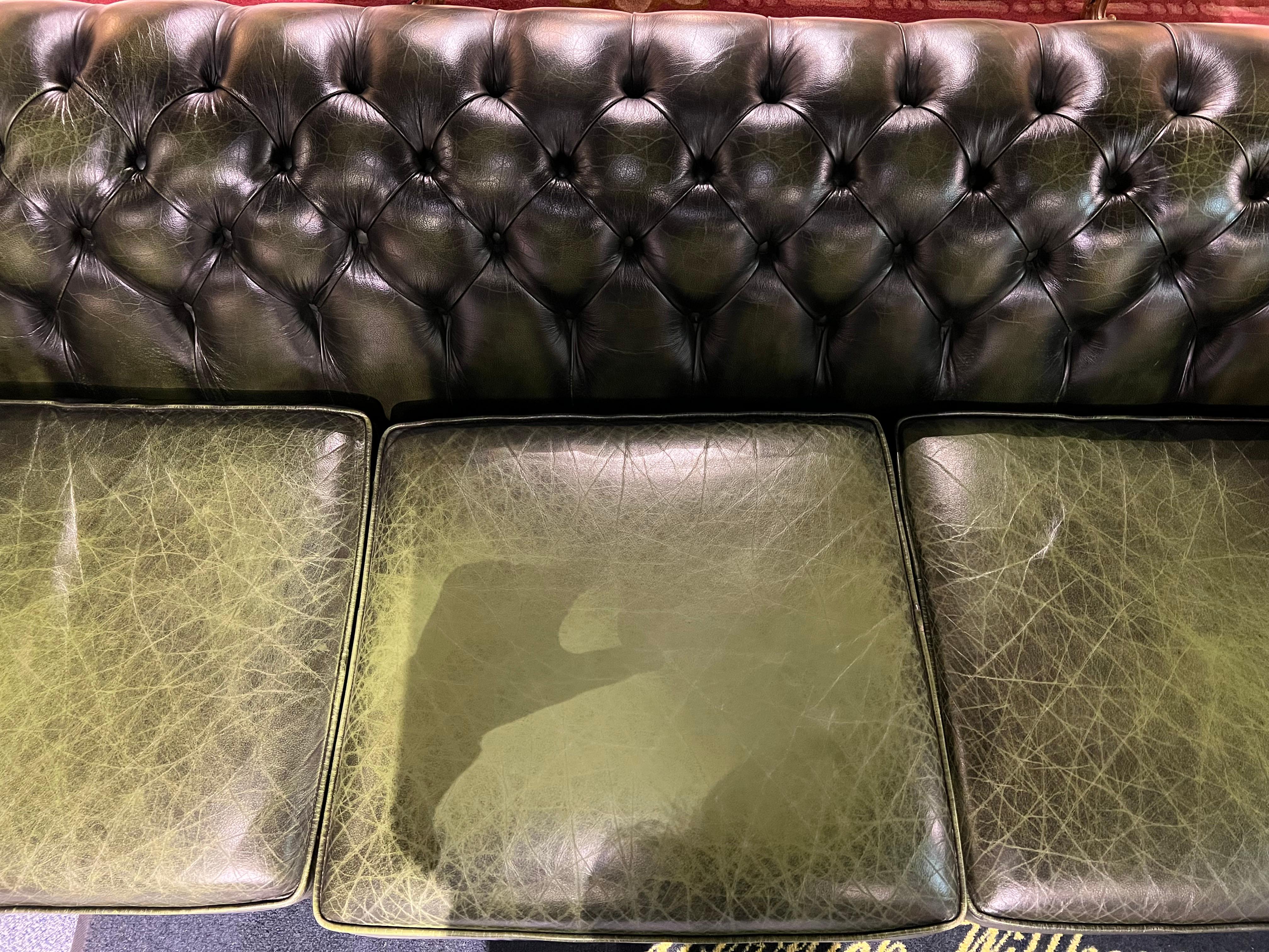 This original beautifully preserved dark green leather Large 4-seater sofa is very masculine and big enough for an office. Coil sprung feather filled cushions - Vintage green leather Chesterfield sofa with original coil sprung front edge and feather