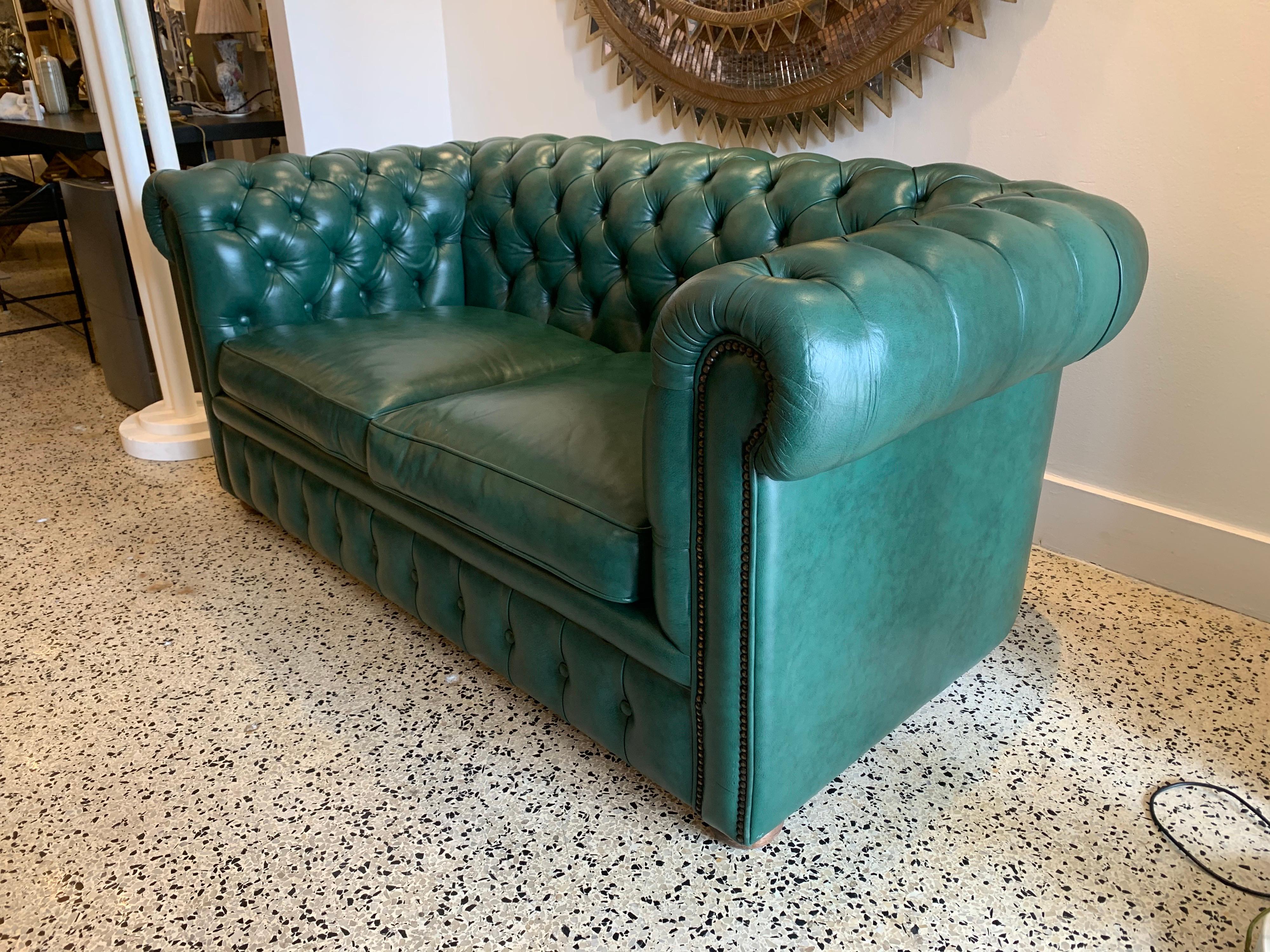 This original beautifully preserved soft hunter green leather small two-seat sofa is very masculine and small enough for an office. Original upholstery and walnut feet. Coil sprung feather filled cushions - Vintage green leather Chesterfield sofa