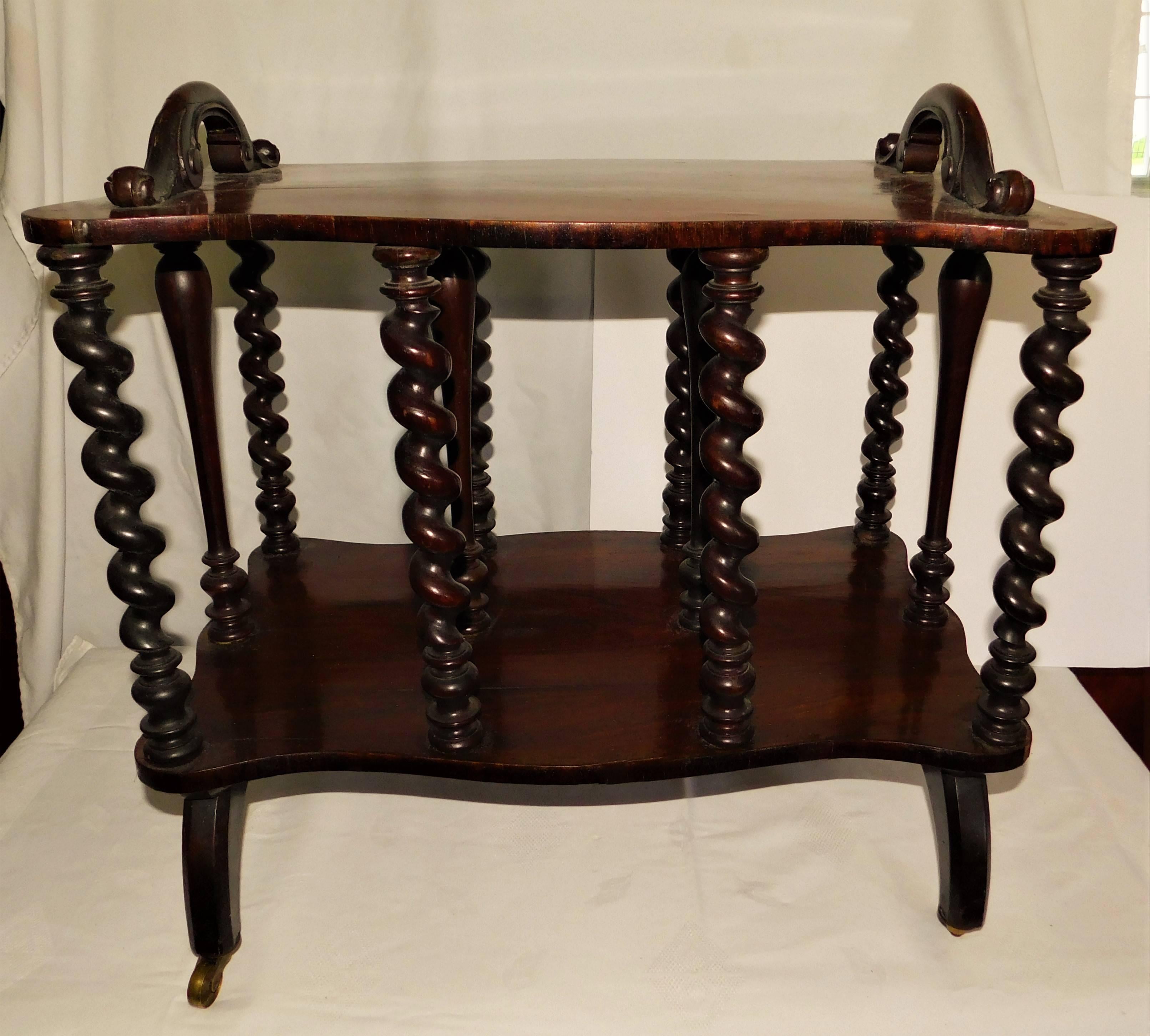 Victorian walnut magazine paper rack table with barley twist columns on castors.