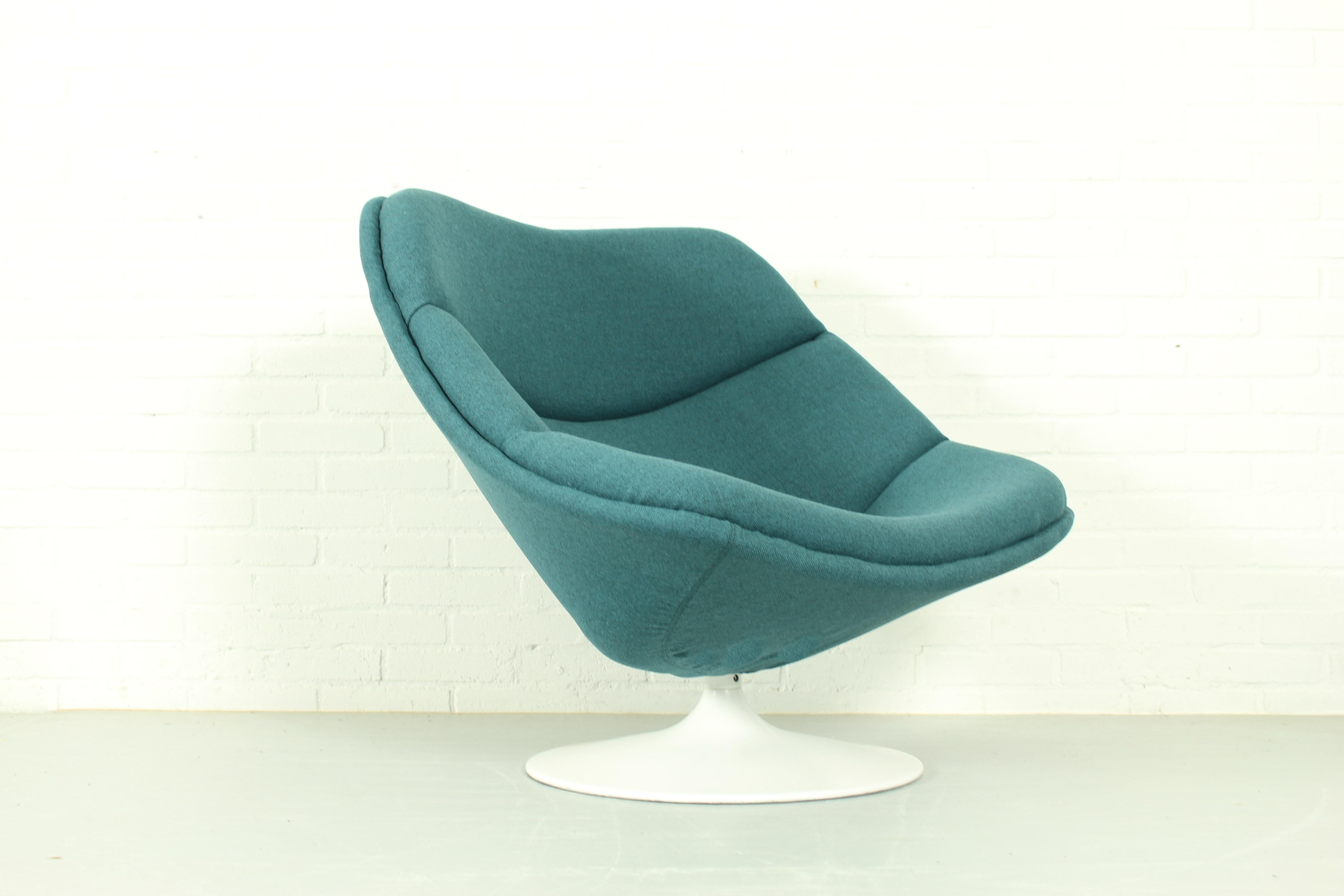 An original F557 swivel lounge chair by Pierre Paulin for Artifort 1960s. This chair has a steel base and is reupholstered in Kvadrat Tonica blue-green fabric. Precursor of the globe chair, this chair is no longer manufactured and was only produced