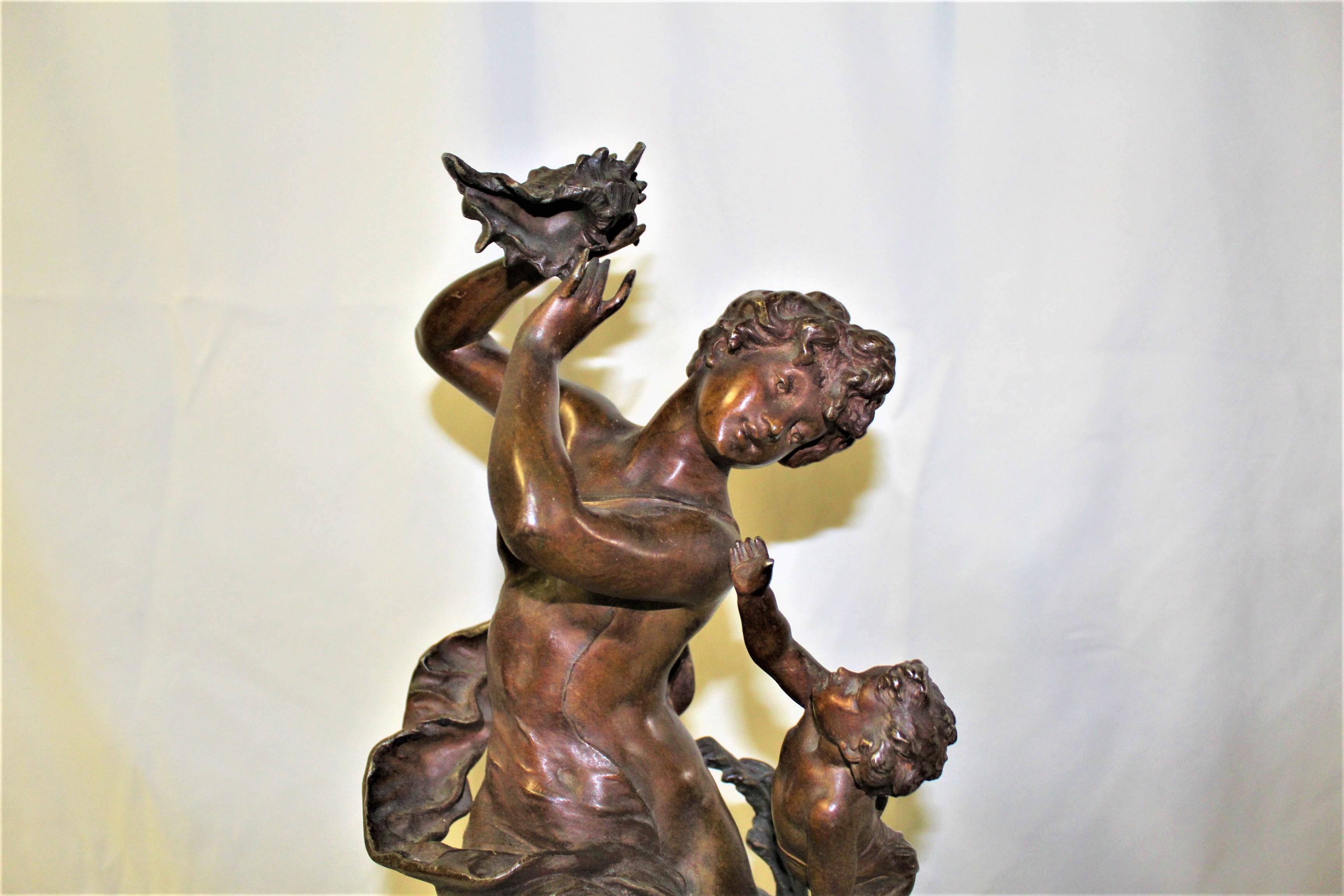 A fantastic subject of a nude young Female sitting on a seashell with a shell in her hand . And with a Putti climbing up to her. Great details in the casting and with a reddish patina . Signed by the Artist Ch Levy and the title is French ( Enfant