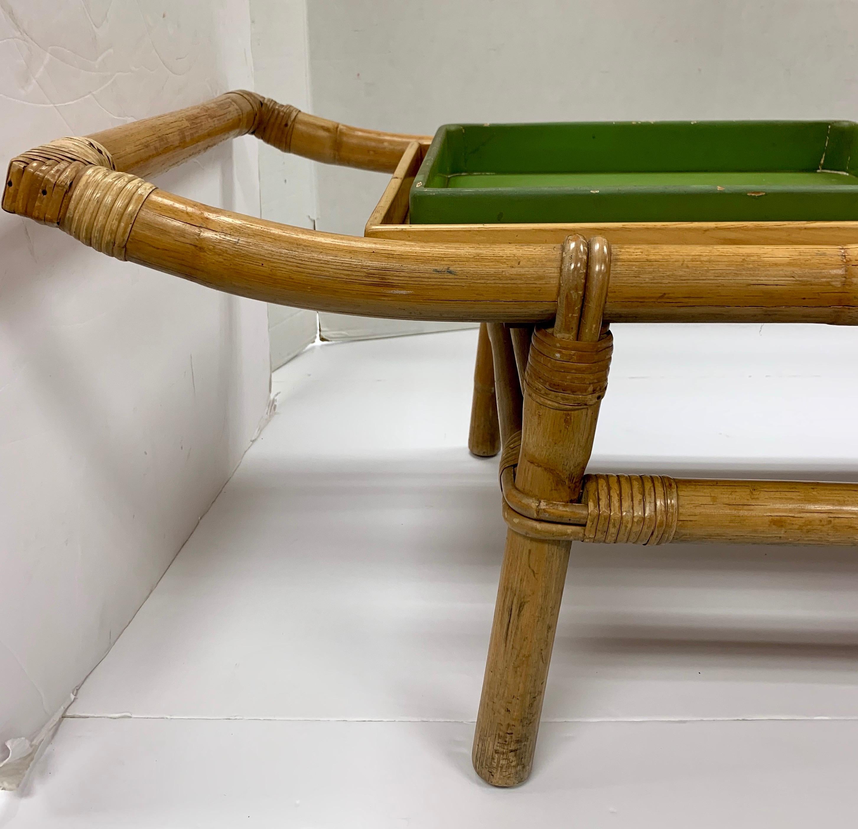 A coveted pagoda form coffee table or bench designed by John Wisner and manufactured for Ficks Reed. This rare Ficks Reed Classic is completely original piece including the green removable trays that adorn each side.
  
The piece is expertly