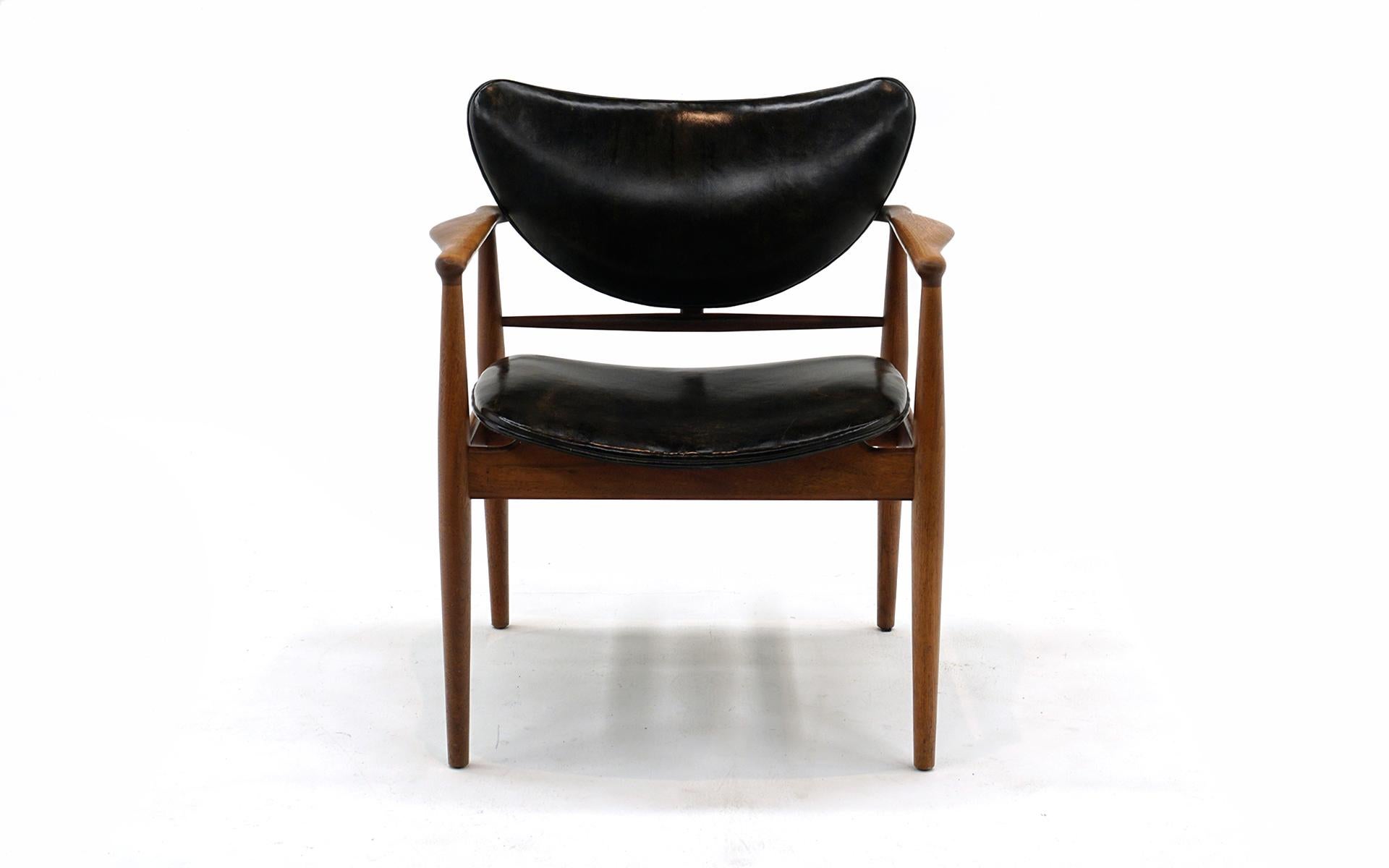 Amazingly well preserved original Finn Juhl Model 48 armchair manufactured by Baker, 1950s.  Original finish with warm patina with original black leather showing what we consider attractive wear.  No tears, holes, or repairs.  This is a great