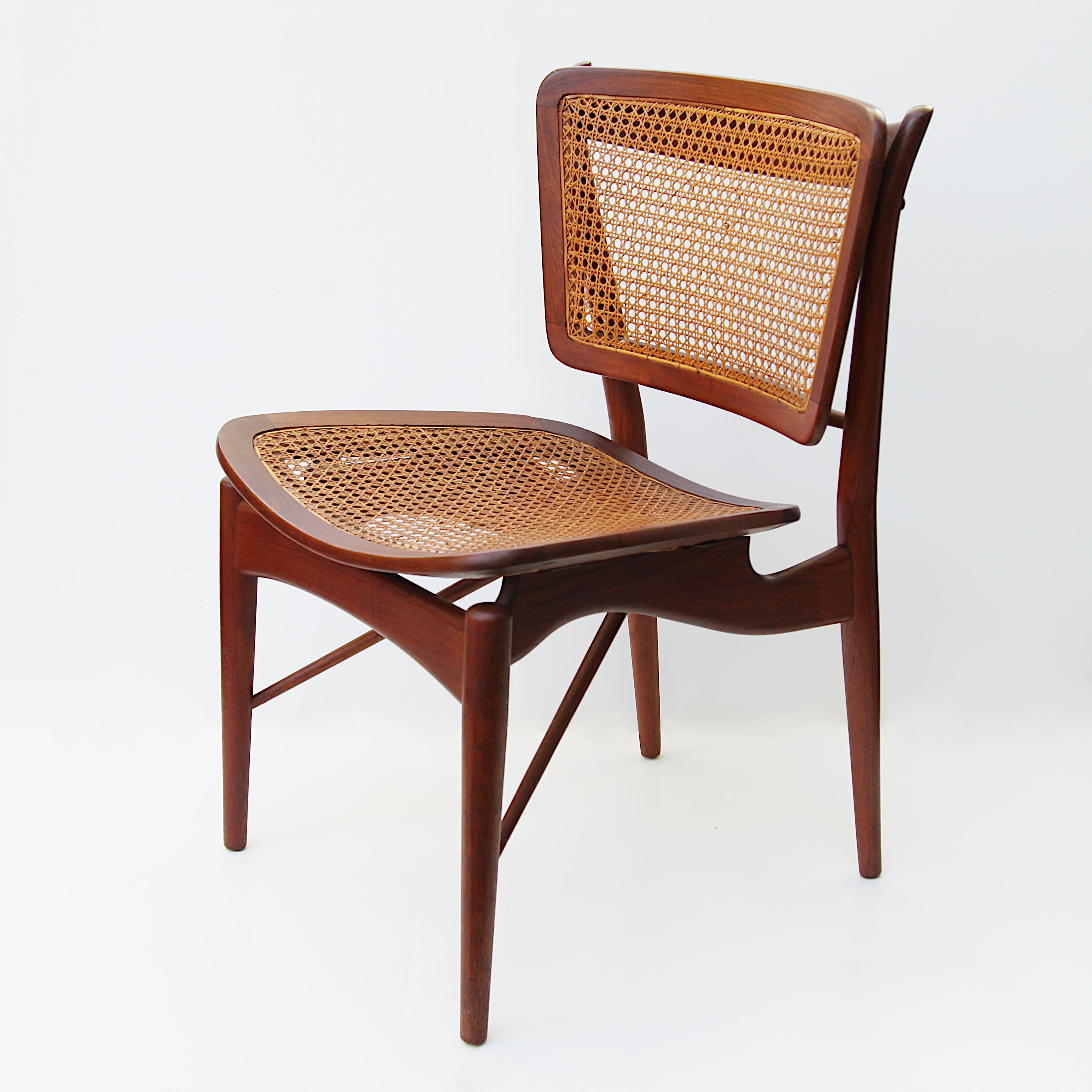 Magnificent Model 51/403 chair designed by Finn Juhl for Baker's Modern line. Chair features beautifully sculpted, solid teak frame and woven cane inserts. This chair is in remarkable original condition with a wonderful patina to the Danish-Oiled