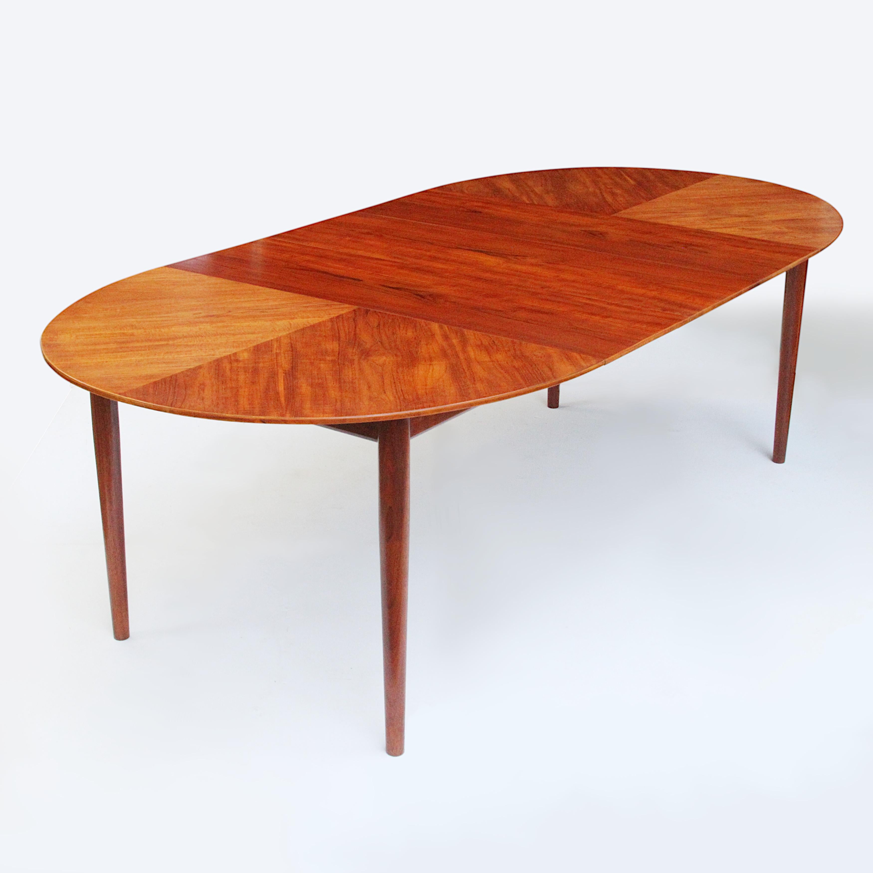 Spectacular dining table designed by Finn Juhl for Baker's Modern line. Table features a beautiful, starburst veneer top, 3 leaves (14