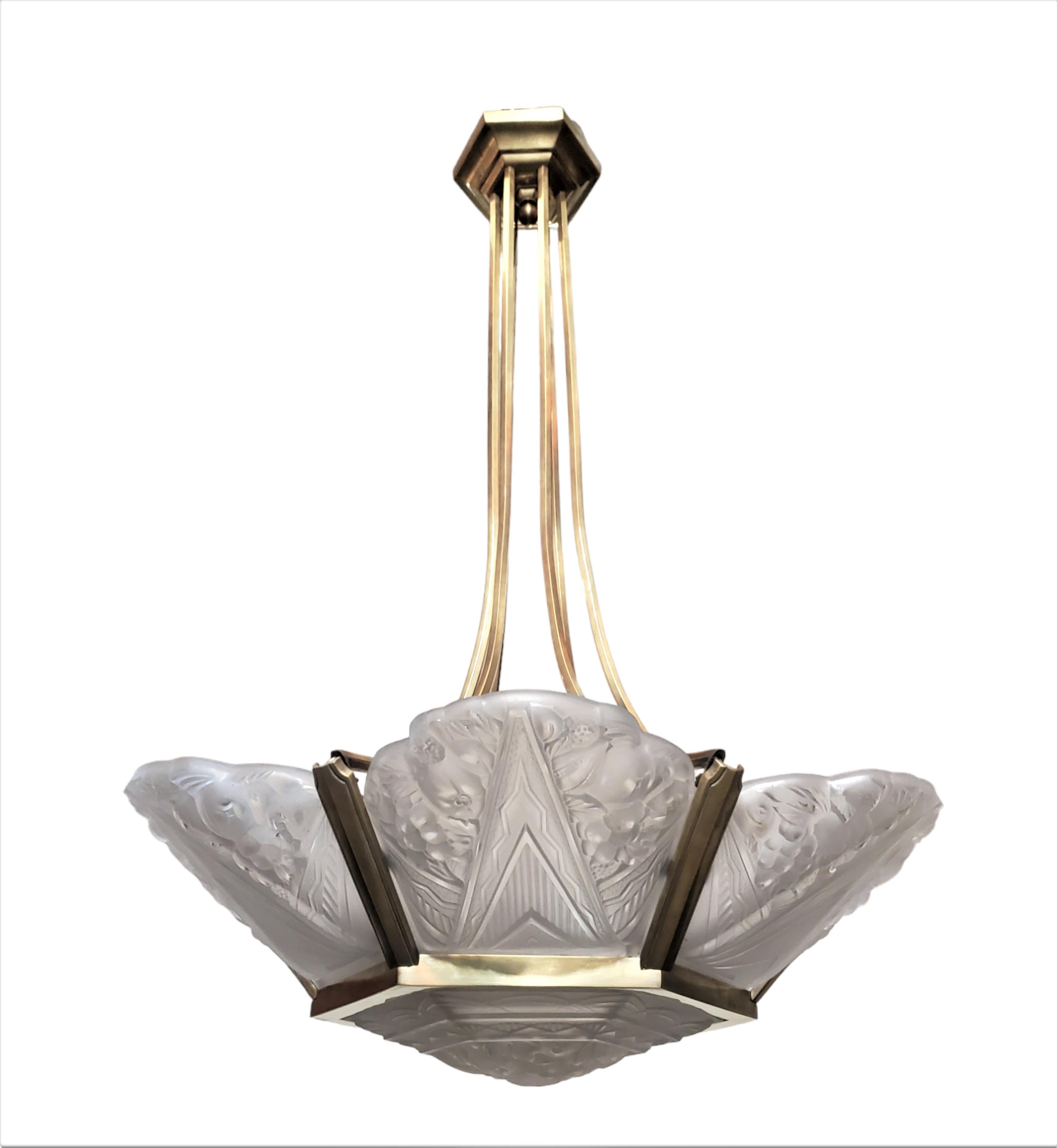 
A fine and authentic French Art Deco period chandelier featuring a blossoming design with six frosted art glass panels and a hexagonal center glass.
 Attributed to Sabino. (Documentation supplied)
The chandelier is elegantly mounted in its original