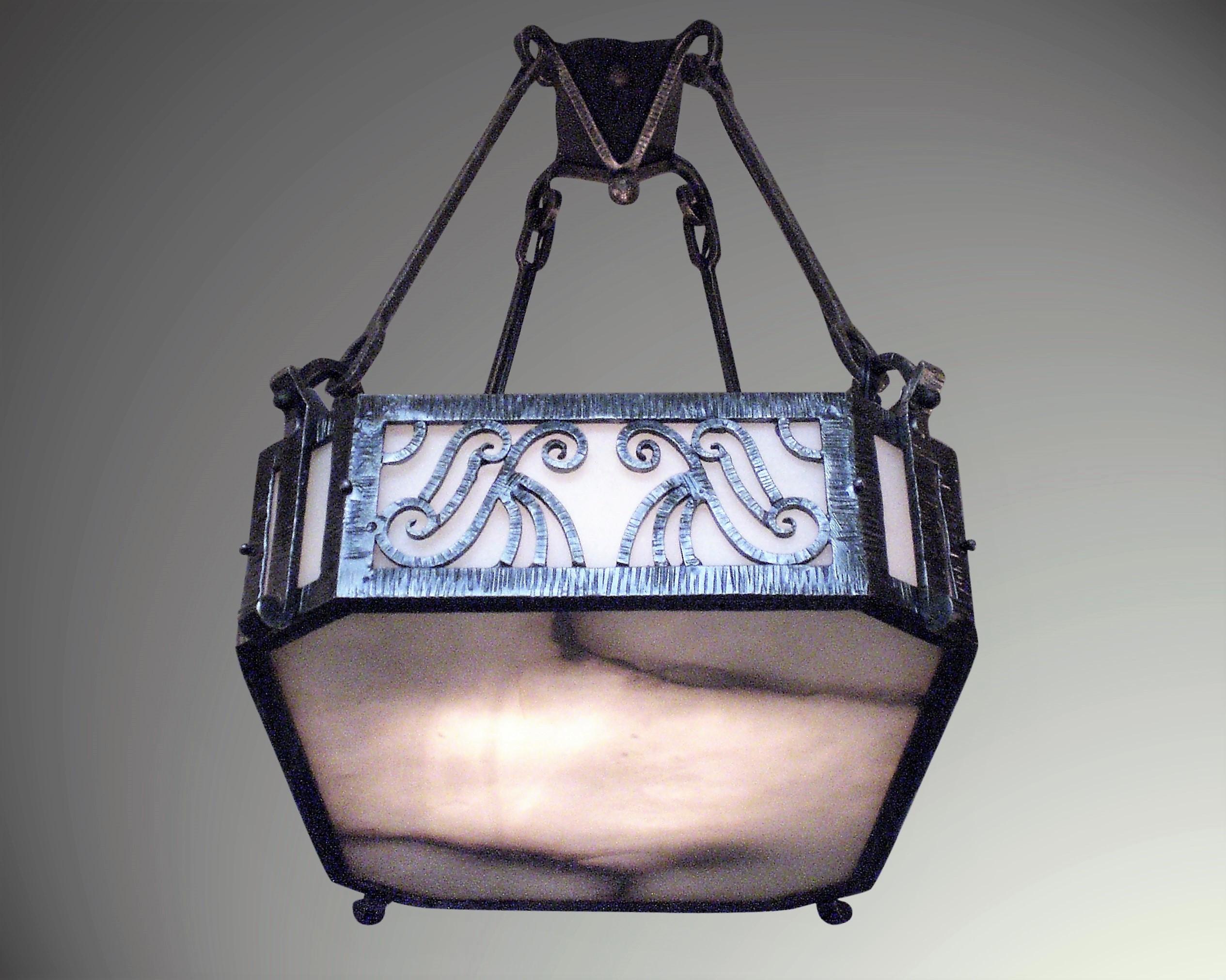 Original hand forged iron and alabaster rectangular shaped chandelier attributed to Edouard Schenck.
 The martele hammering and patterning on the fer forge is of fine quality. The stem and unusually shaped canopy are all intact and original to the