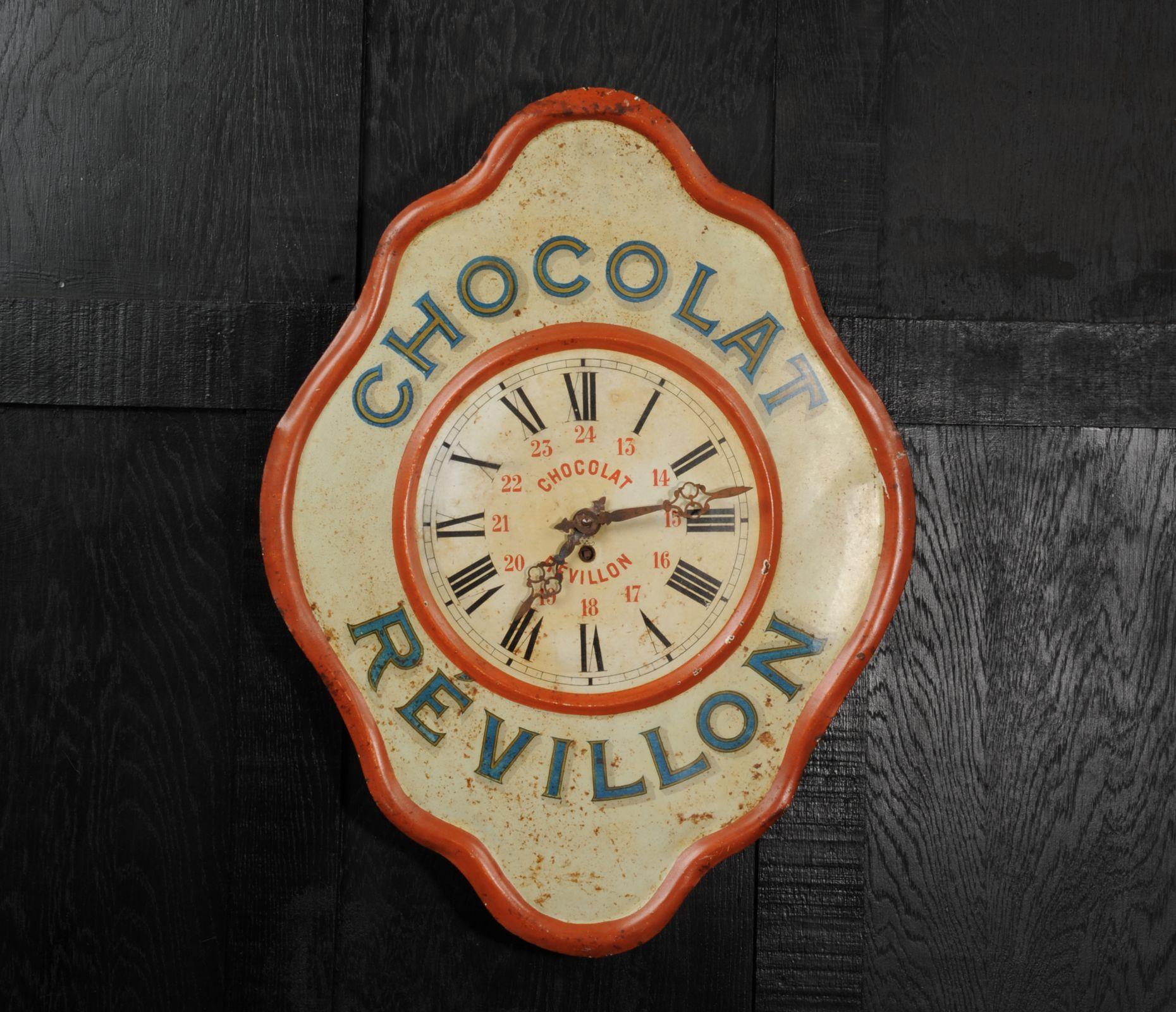 A wonderful original Révillon Chocolatier tole advertising clock, circa 1920. Found by our buyer in a long derelict French bar it has been worn by years of neglect with a wonderful ancient craquelure and a patina of paint loss and rust. The fine
