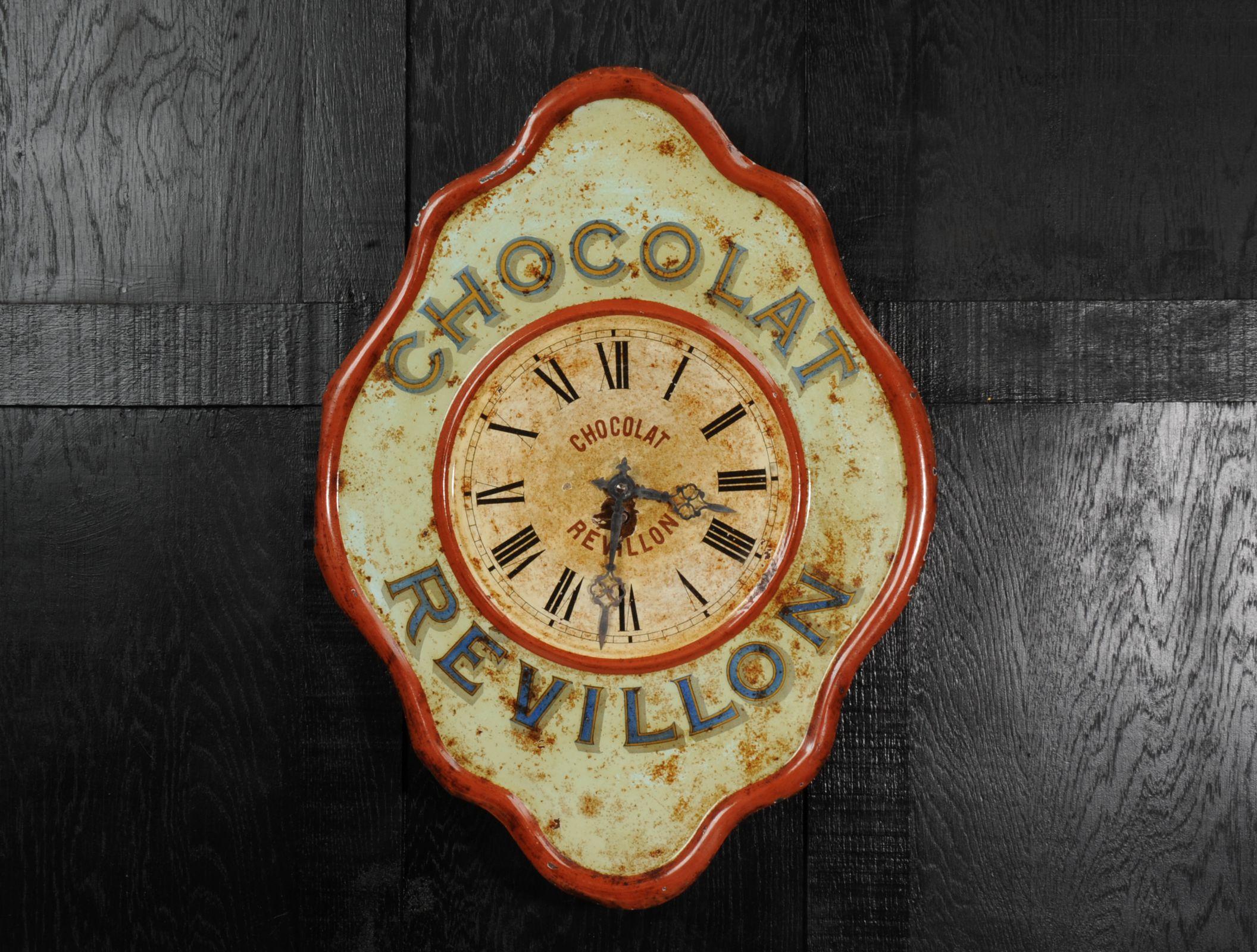 A wonderful original Révillon Chocolatier tole advertising clock, circa 1920. Found by our buyer in a long derelict French bar it has been worn by years of neglect with a wonderful ancient craquelure and a patina of paint loss and rust. The fine