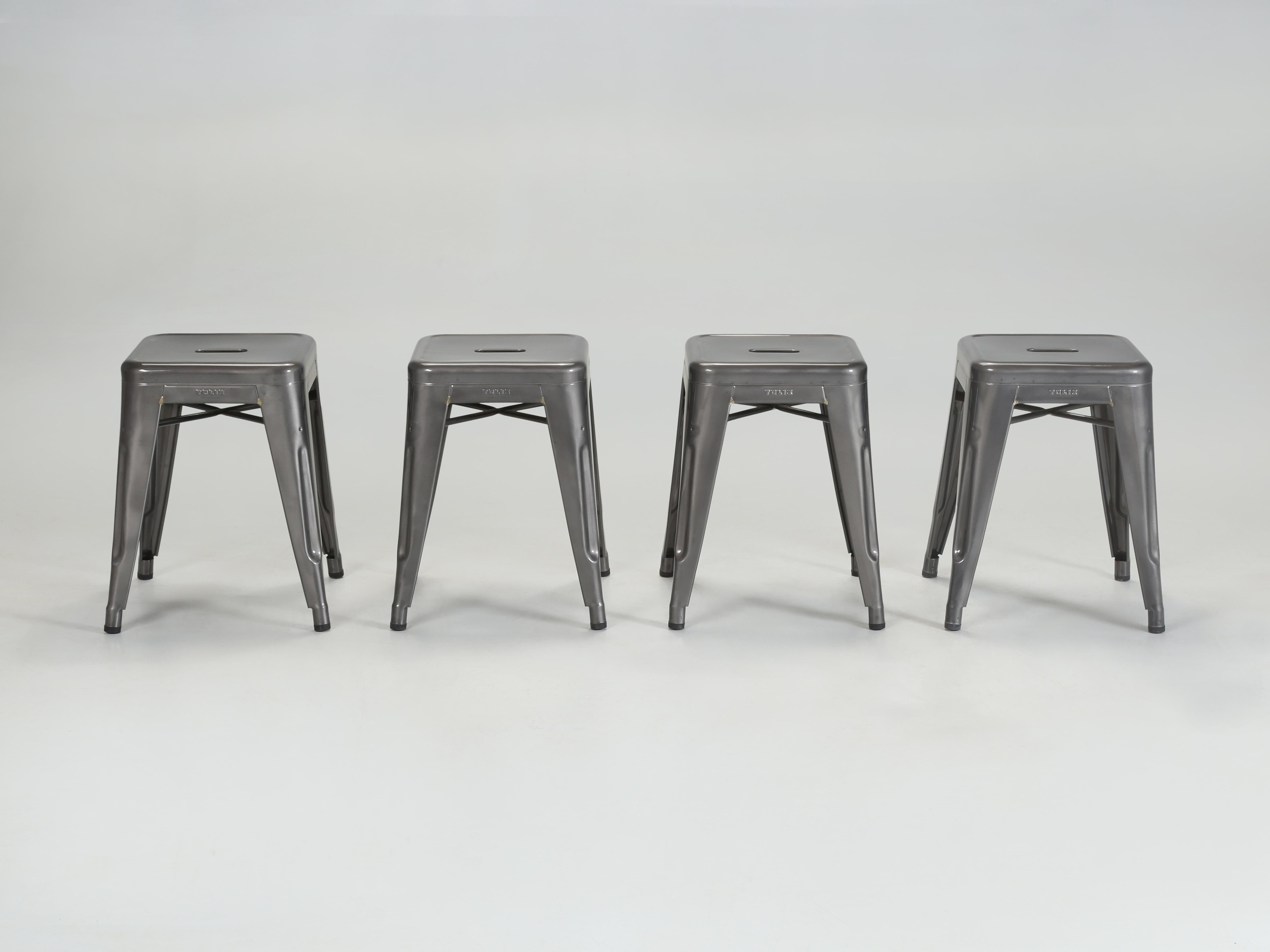 Set of (4) Original French Tolix Dining Table Height Glossy Dark Grey Powder-Coated Welded Steel Stacking Stools. The Tolix Dining Table Height Stools are the same height as a dining chair at 18