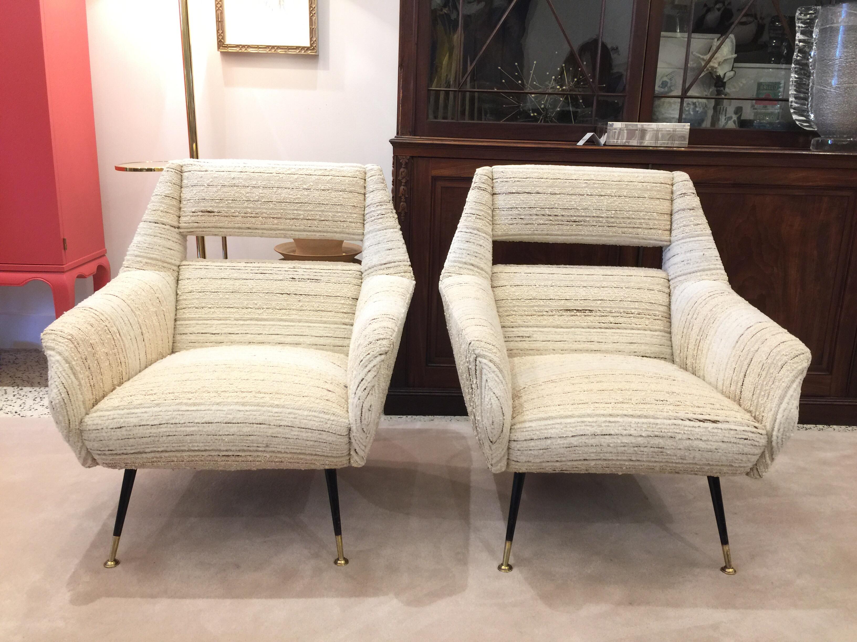 Sculptural cut-out design in these Classic Italian armchairs with blackened metal and brass capped feet. ALL vintage and expertly refurbished and finished in wonderful nubby wool (lines of browns, greys and beige).