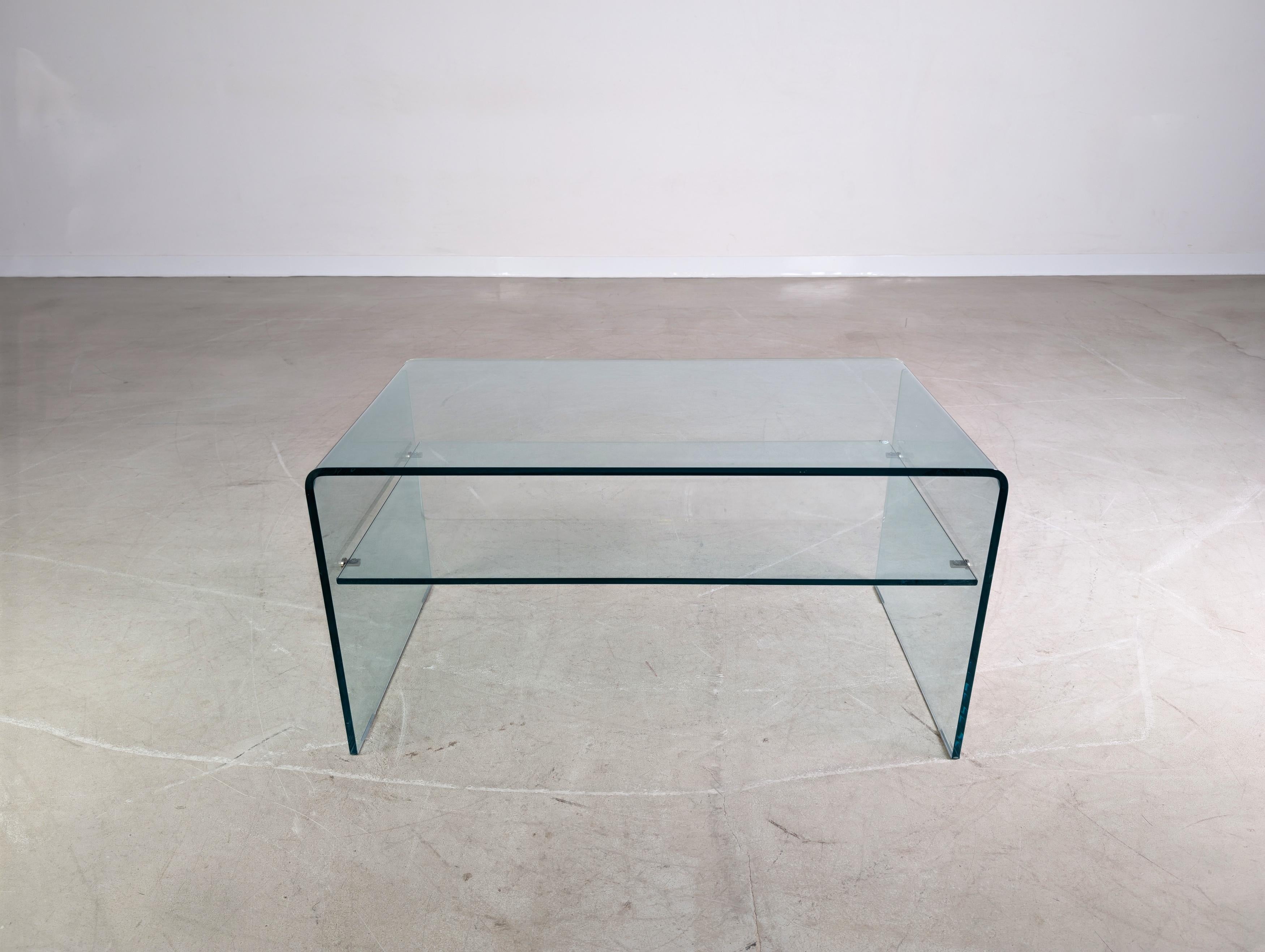 Te ofrecemos un magnífico sofá cama de Sovet Italia fabricado en cristal sintético. La mesa se distingue por su acabado de alta calidad y cuenta con un cuerpo auxiliar bajo la placa de la mesa, que tiene un ligero revestimiento en cada lado. Die