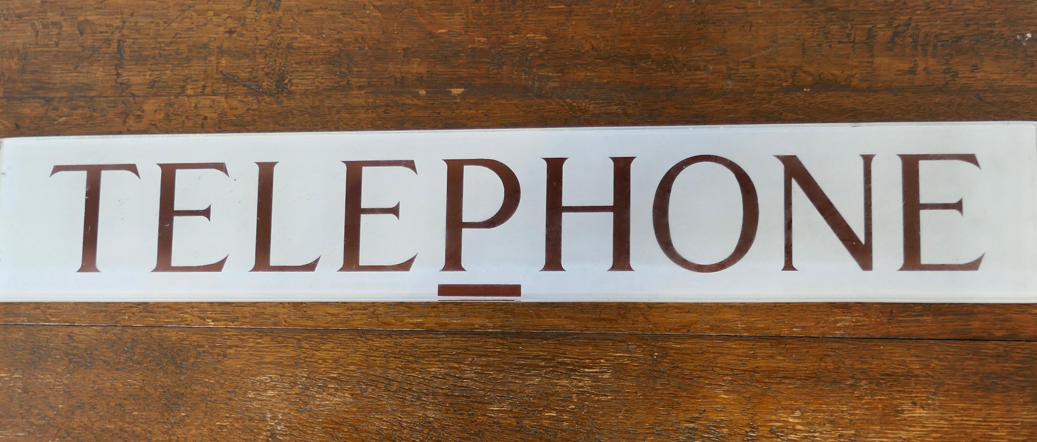 Original GPO Glass “TELEPHONE” sign from a Red Phone Box

From the 1950s the thick glass Telephone sign is in good original Condition

The sign is 4” high and 25” long
FB241
