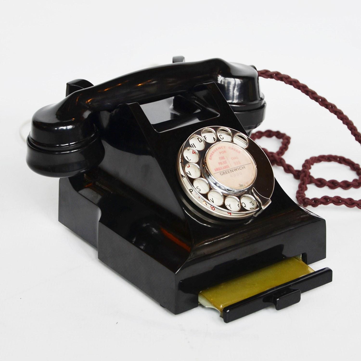 An original GPO model 312L telephone. Black bakelite with integral drawer and braided handset cord. Registered number to face. Call exchange feature.

Dimensions: H 15cm, W 20cm, D 16cm

Origin: English

Date: 1952

Item No: 110209

All of