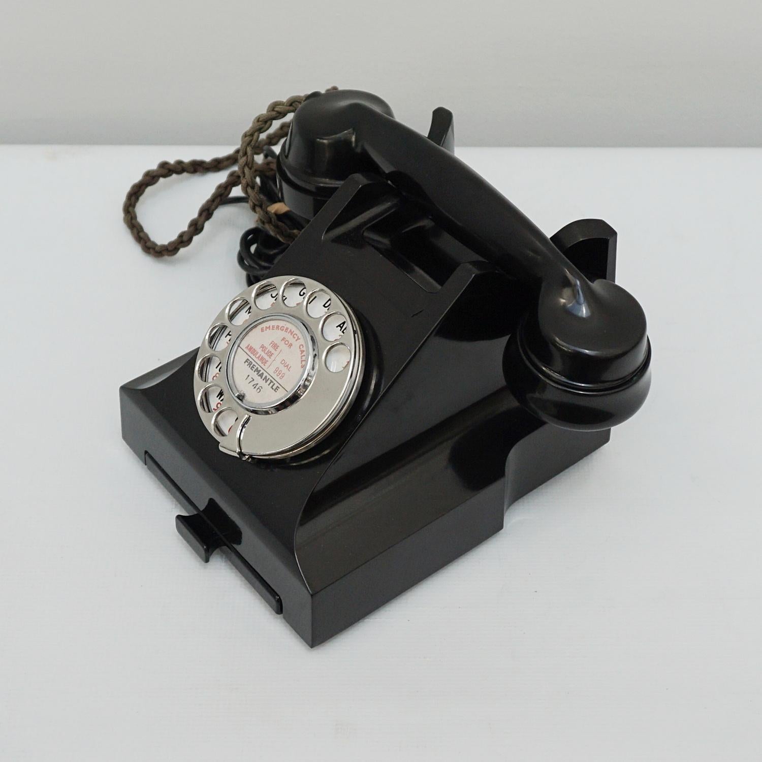 An original GPO model 332L Telephone. Black bakelite with integral drawer and braided handset cord. Registered number to face.

Dimensions: H 15cm, W 20cm, D 16cm

Origin: English

Date: Circa 1950

Item No: F1703227

All of our telephones