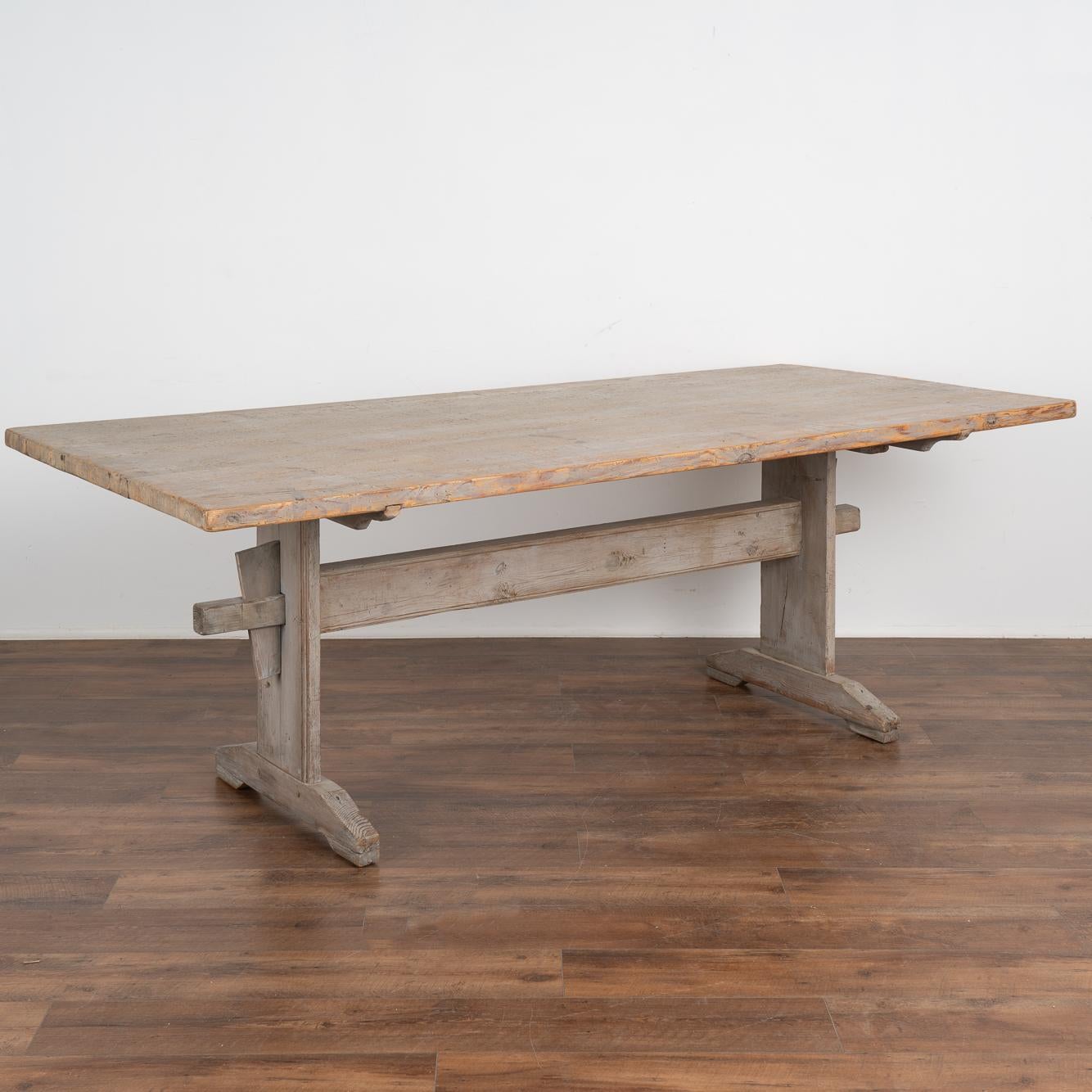 This wonderful old farm table from the Swedish countryside is a special find thanks to the original gray painted finish which has been worn down to the warm pine patina below through generations of use. 
The top is deeper than most of the era at