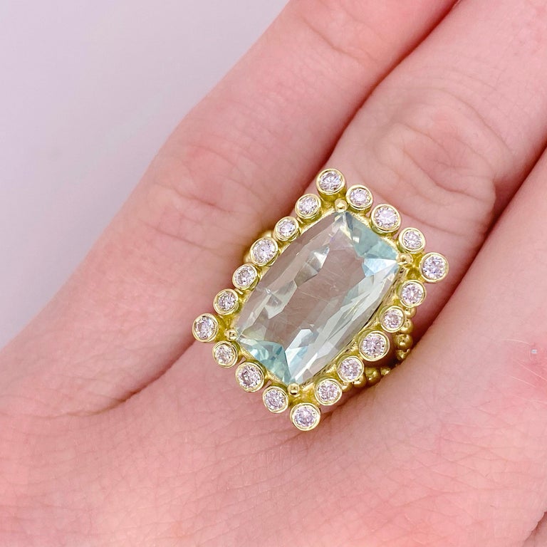 This original and one-of-a-kind ring was designed by Mary Rupert of Five Star Jewelry.  Molded in 18K Yellow Gold this lovely ring has a unique style with twenty diamonds around it! The ring has a fancy cut mint green tourmaline that is so original