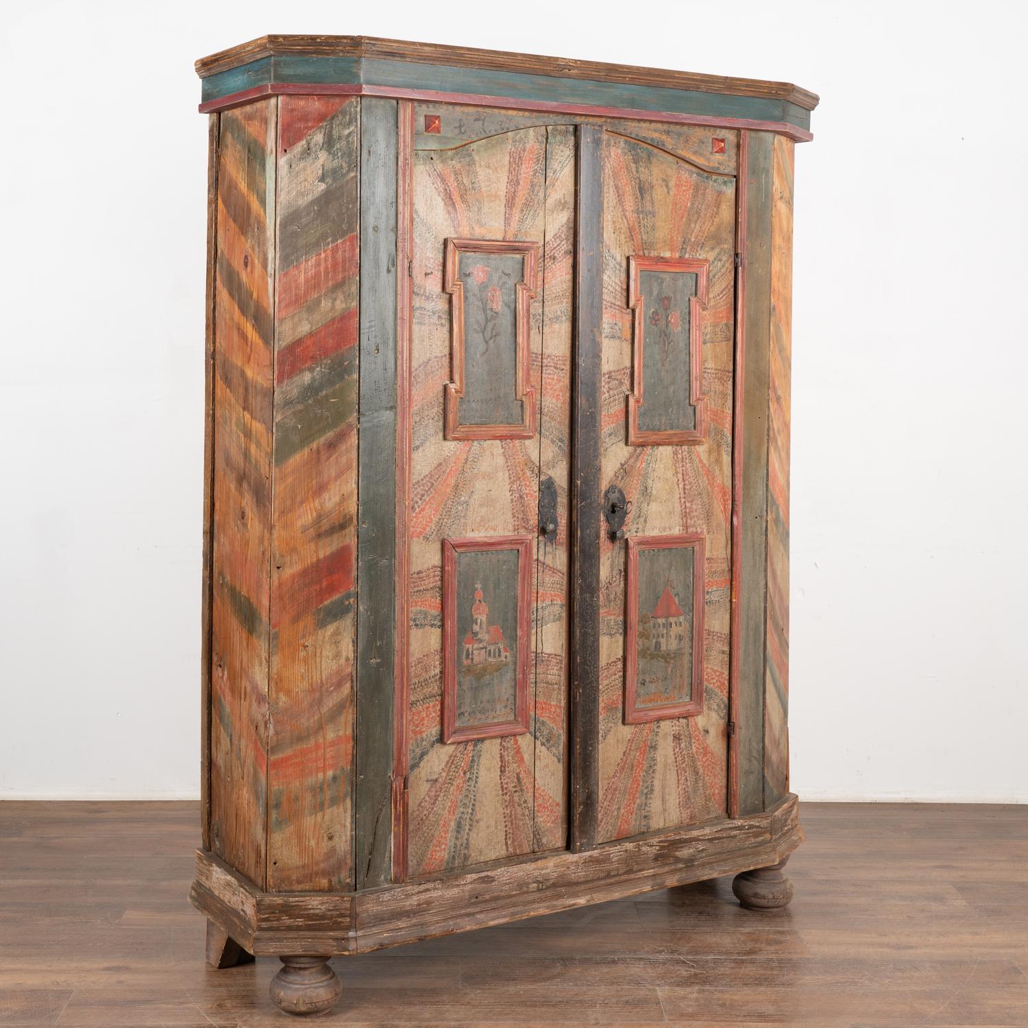 This original painted armoire still maintains the quality and details of the hand-painted finish with unique and colorful background. Shades of green, teal blue, red and brown are all on display.
Date of 1785 is faintly visible along the upper
