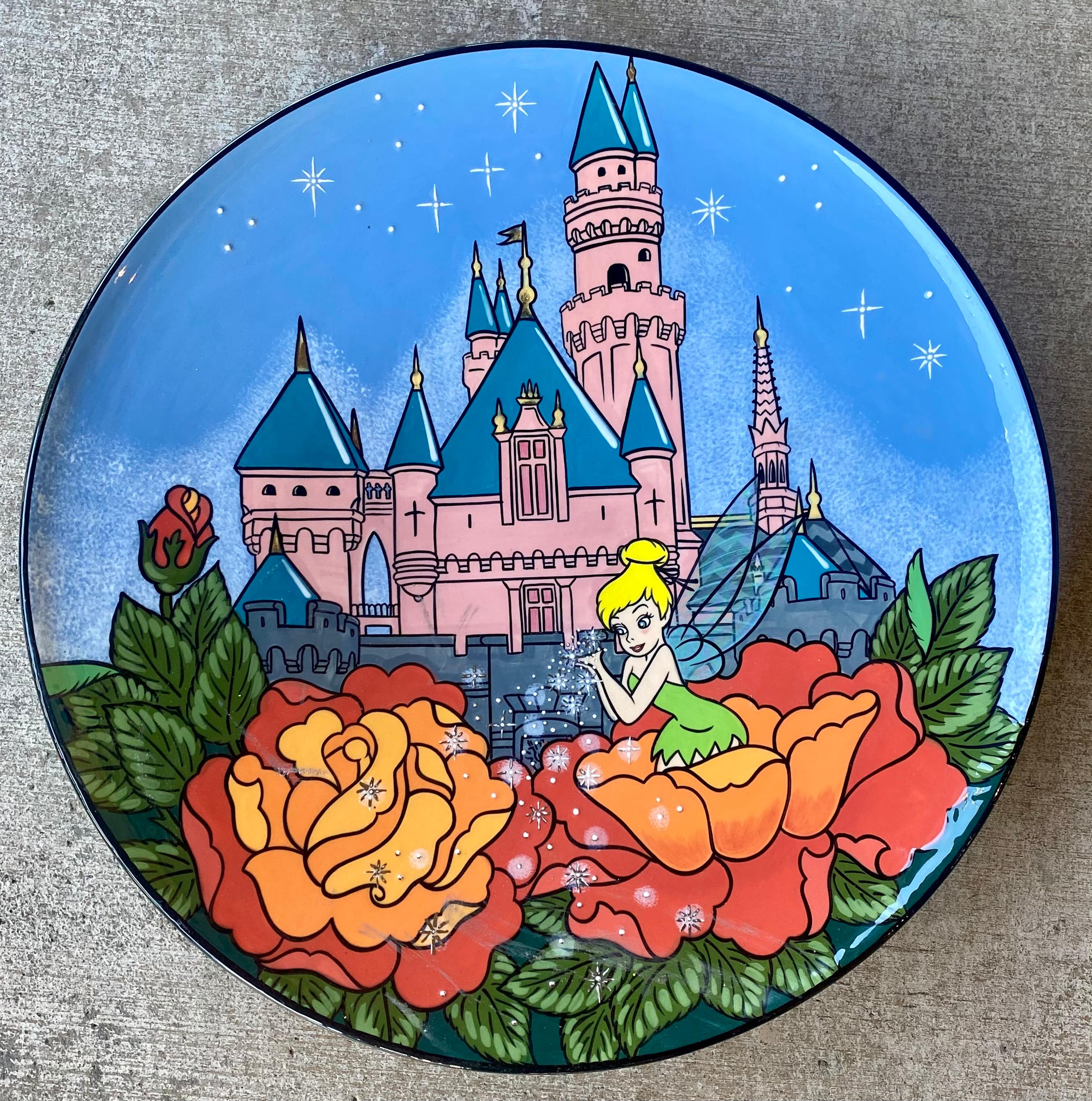 Collectible large, hand made tinker bell and the Disneyland Magic Kingdom castle original art plate by Disney artist, Elisabete Gomes. Ceramic plate features a vividly hand painted scene of the famous Magic Kingdom castle and tinker bell sitting