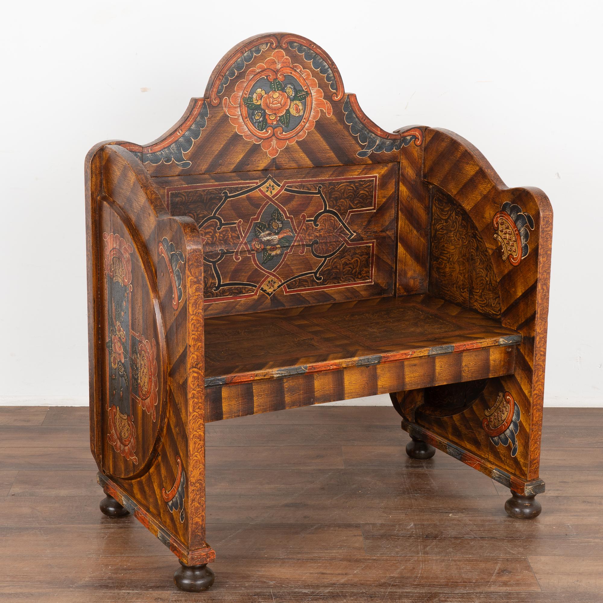 This delightful high back bench is a rare find due to it's unique small size and elaborate original hand-painted finish.
Please enlarge photos to appreciate the many details of the painted finish, with traditional faux wood background, orange/red,
