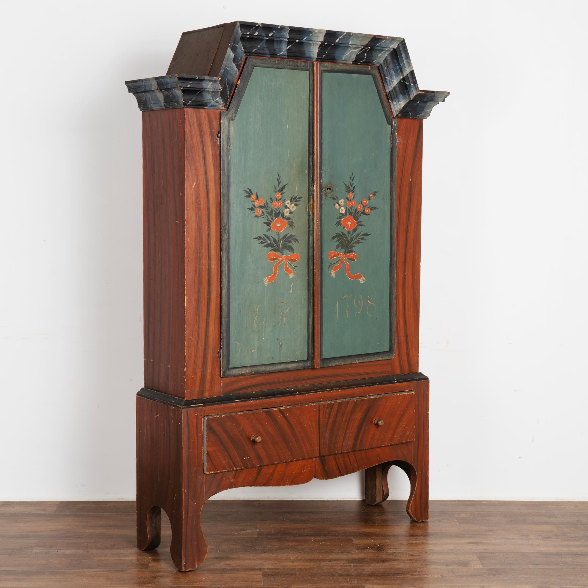 Painted cabinets were a traditional element of Swedish country homes, this one is particularly lovely as it still maintains the original hand-painted finish with floral bouquet and faux wood painted background which was the folk art style of the