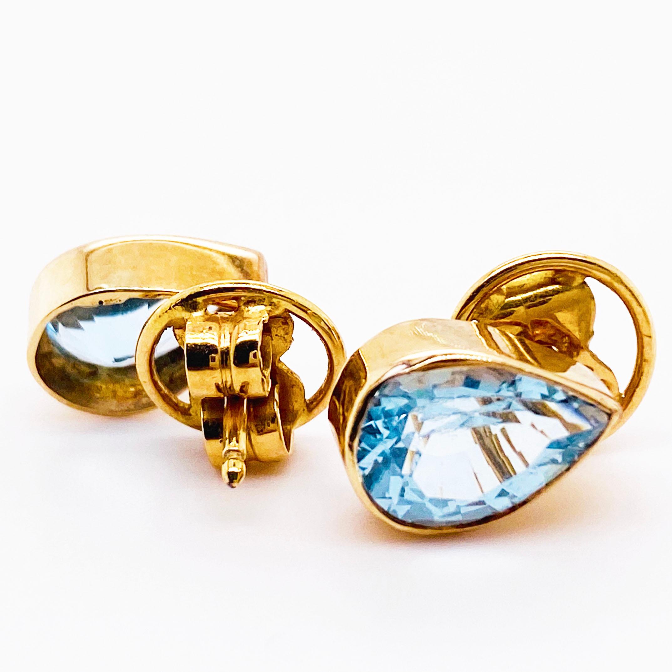 These Original Pear Blue Topaz Yellow Gold Stud Earrings Were Hand Fabricated In Solid 14 Karat Bezels and weigh over 5 carats. The earrings were gently created in our shop using the gemstones, 14 karat gold sheet, and earring posts and extra large