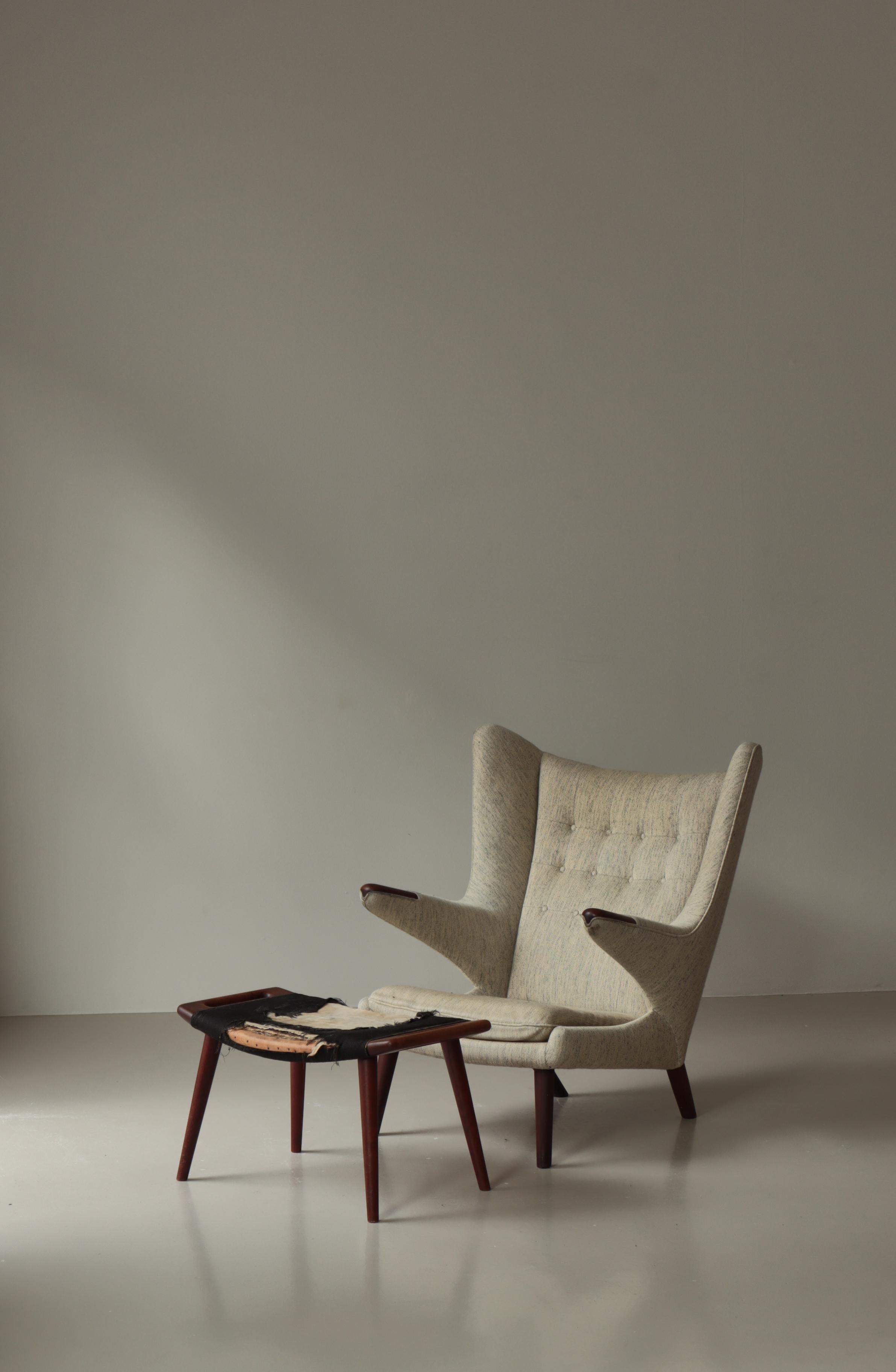 An exceptional and authentic mid-century masterpiece, this original Hans J. Wegner “Papa Bear” chair with its corresponding ottoman—both produced in the 1950s by A.P. Stolen—embodies the very essence of Danish modern design. Rare to find as a