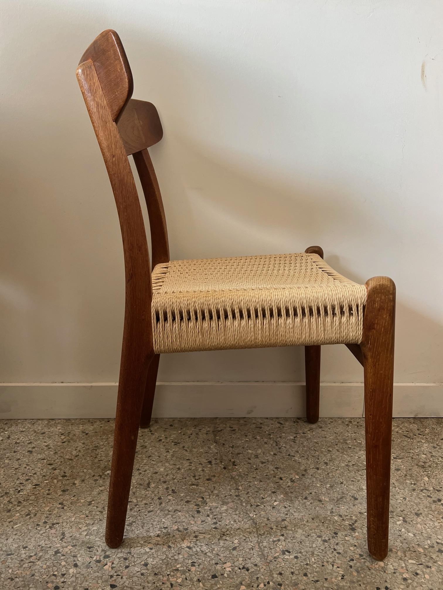 A Classic and beautiful, vintage Hans Wegner CH 23 chair made of teak and oak, with cord seat. Great patina and character which you cannot get with new chairs. Perfect as a desk chair or occasional chair. Manufactured by Odense, Denmark, circa 1960s.