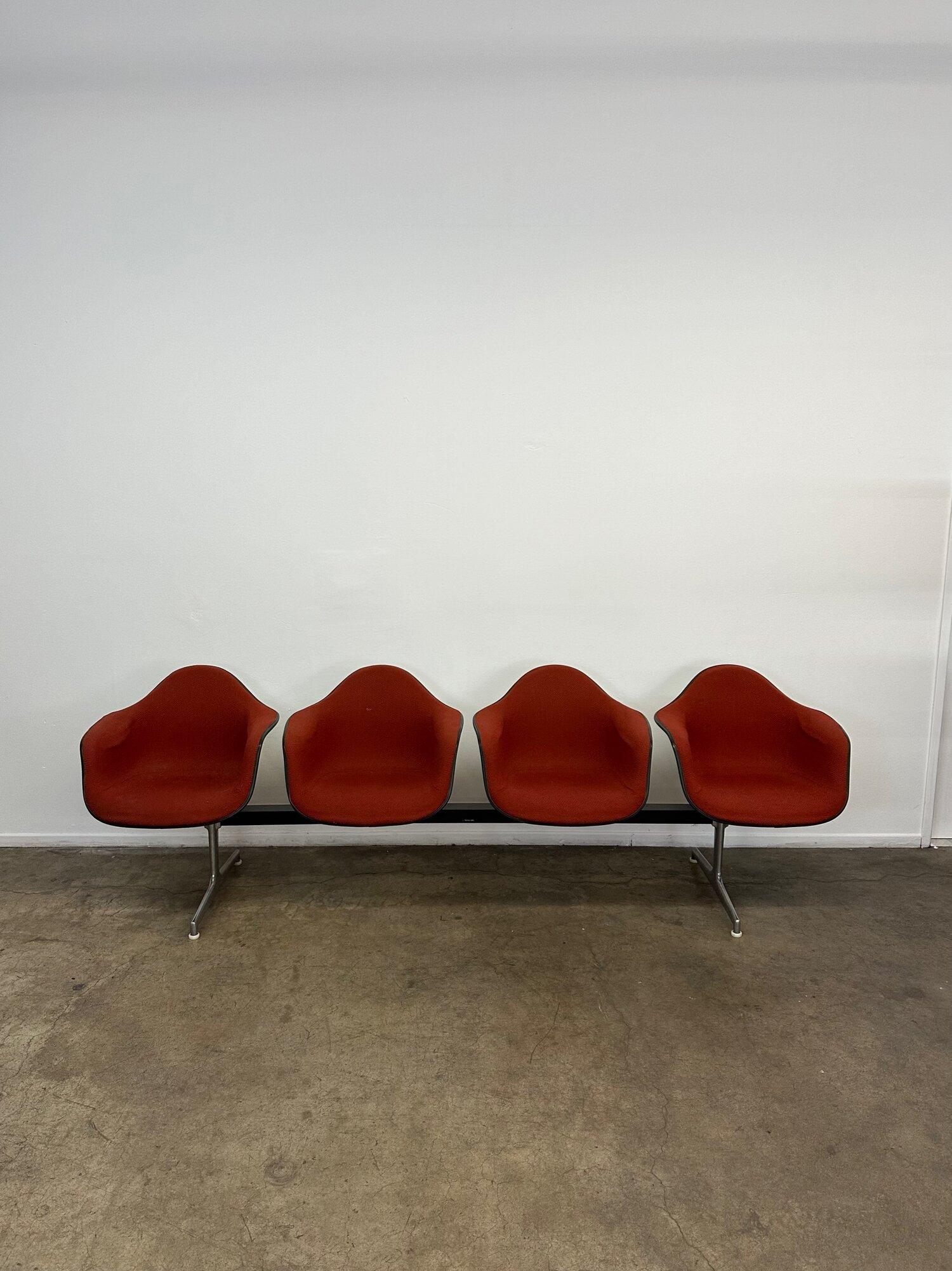 W103 D23 H32 SW25 SD17 SH17.5 AH26

Original four seater bench in deep red fabric. The seat is molded out of fiber glass. Original, with makers mark attached. Chrome details with matte black metal frames. Original Herman Miller tag found below