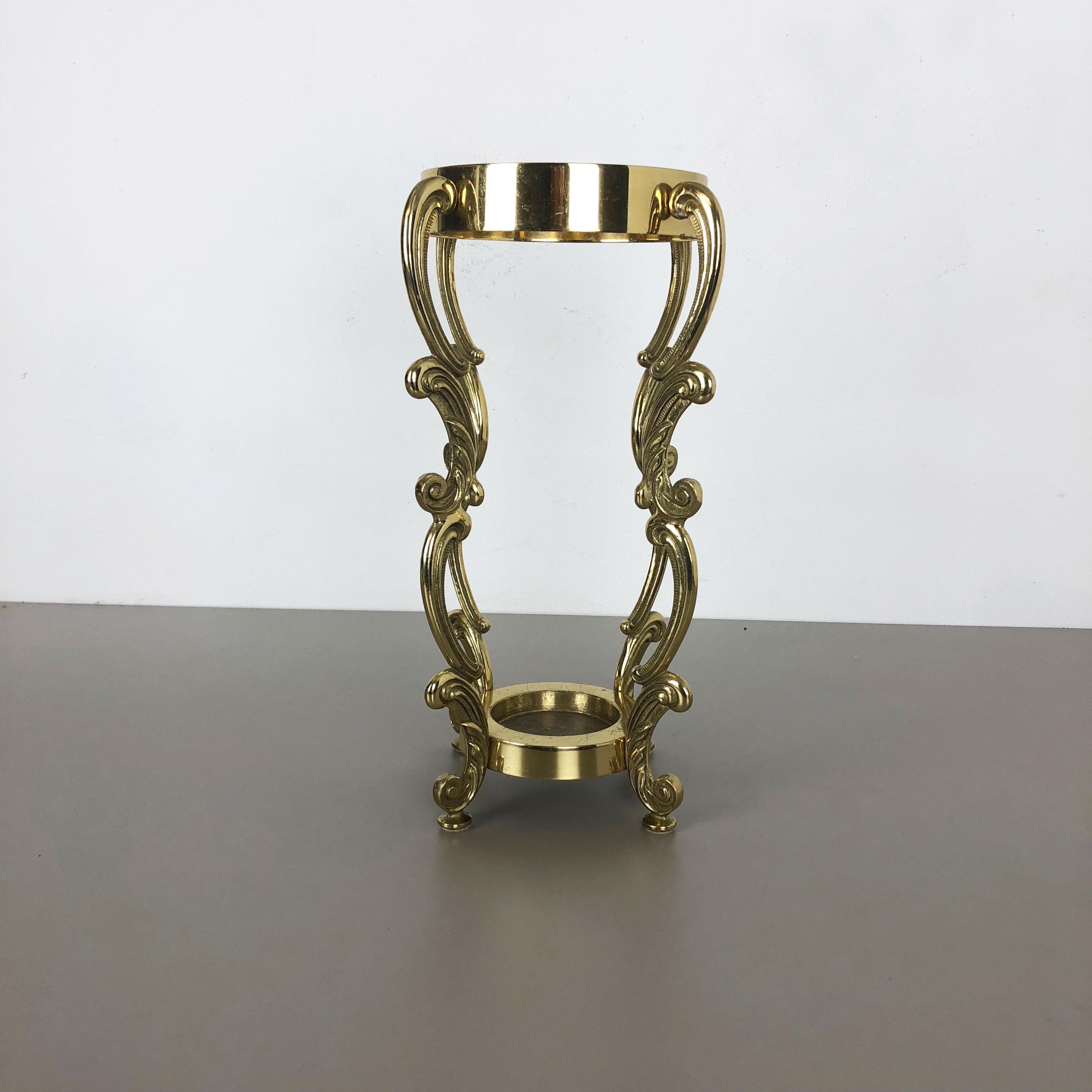 Article:

Umbrella stand Hollywood Regency.


Origin:

Italy, sold to end customer in Germany.


Age:

1970s


This original vintage Hollywood Regency umbrella stand was produced in the 1970s in Italy. It is made of solid brass and
