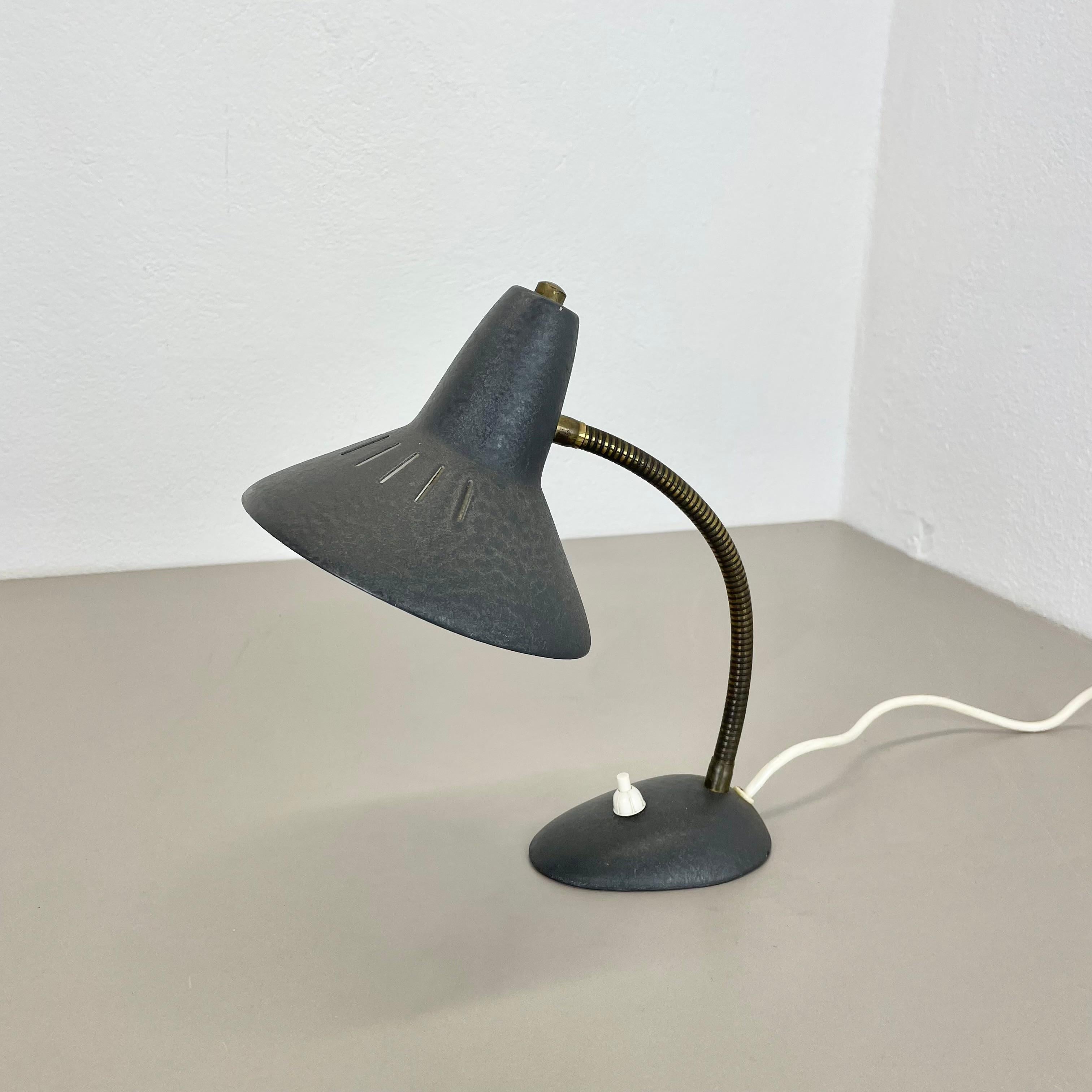 Article:

modernist grey metal and brass table light 


Origin:

Italy


Decade:

1950s



This original vintage light was designed and produced in the 1950s in Italy. The light is made of metal in original grey tone and  brass with a nice formed