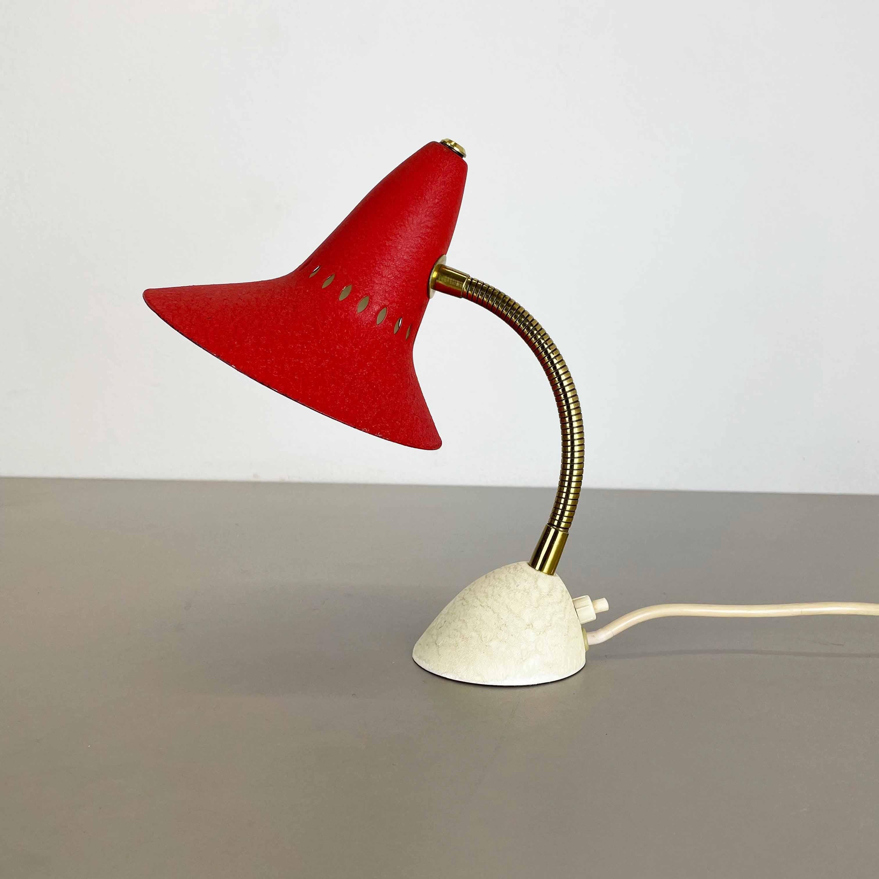 Article:

modernist table light in style of STILNOVO design


Origin:

Italy


Decade:

1950s





This original vintage light was designed and produced in the 1950s in Italy. The light is made of metal and has witch hat formed red