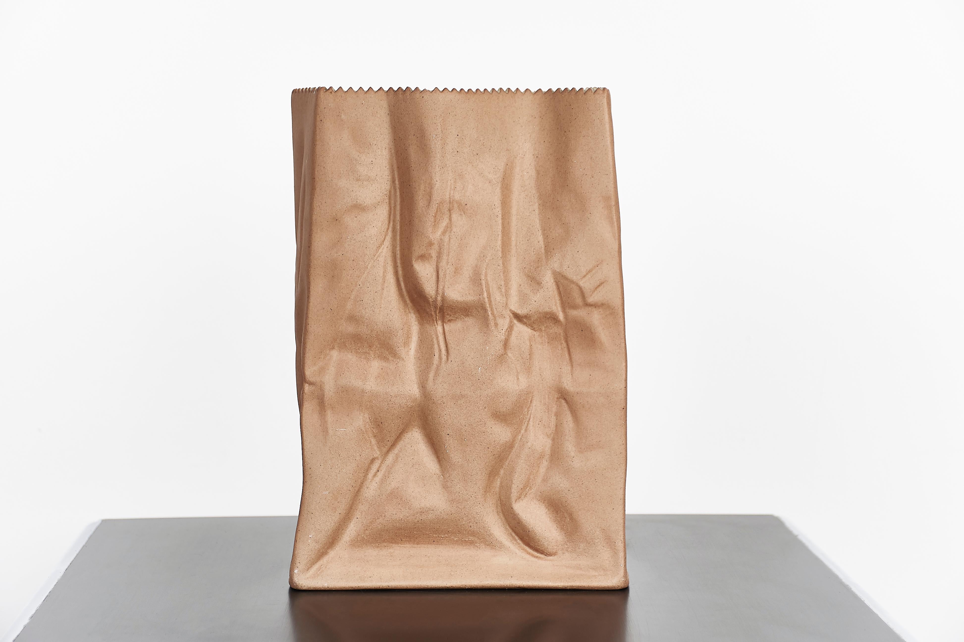 Paper or plastic or…Wirkkala’s fun and whimsical 1977 Pop Art take on tromp l’oeil, something that is not what it appears to be. Here, a used paper bag is actually a porcelain vase. Kraft paper brown with a serrated top edge. Perennially popular and