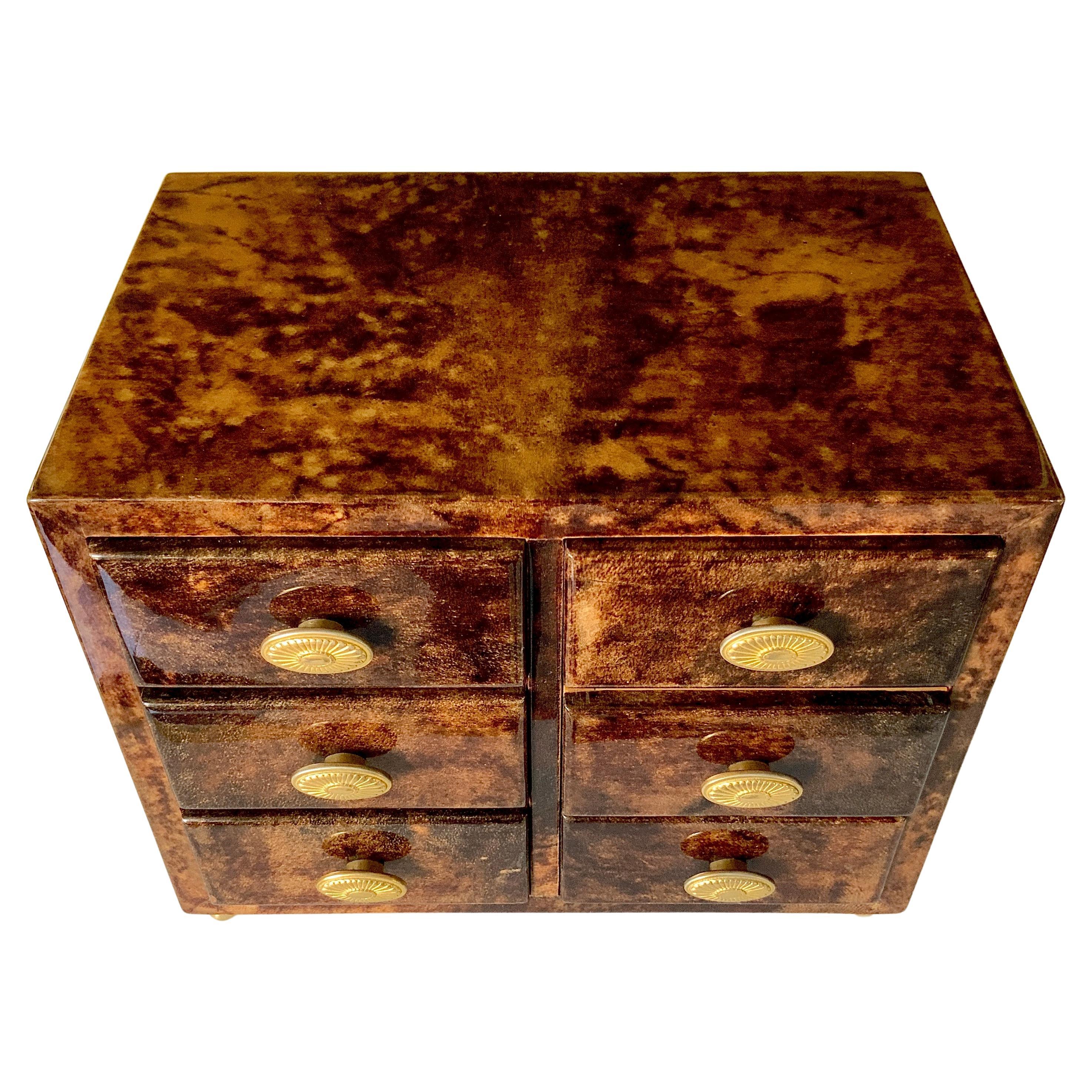 A fabulous vintage Aldo Tura Goatskin Jewelry Chest. The quality is impeccable. The beautiful goatskin with 6 drawers in fine wood and 5 have the original green velvet to lay your jewelry on. The knobs on the drawers are gold plated brass. 4 brass
