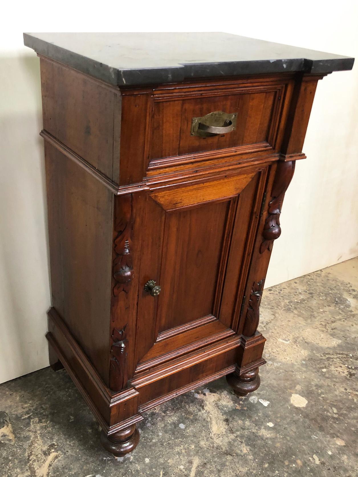 Original uncommon Italian night stand in walnut and fire and with black original marble top. 
All the carvings on the solid walnut parts were done manually.
They have a nice design and are very practical.
It is right.
Given the weight and size, it