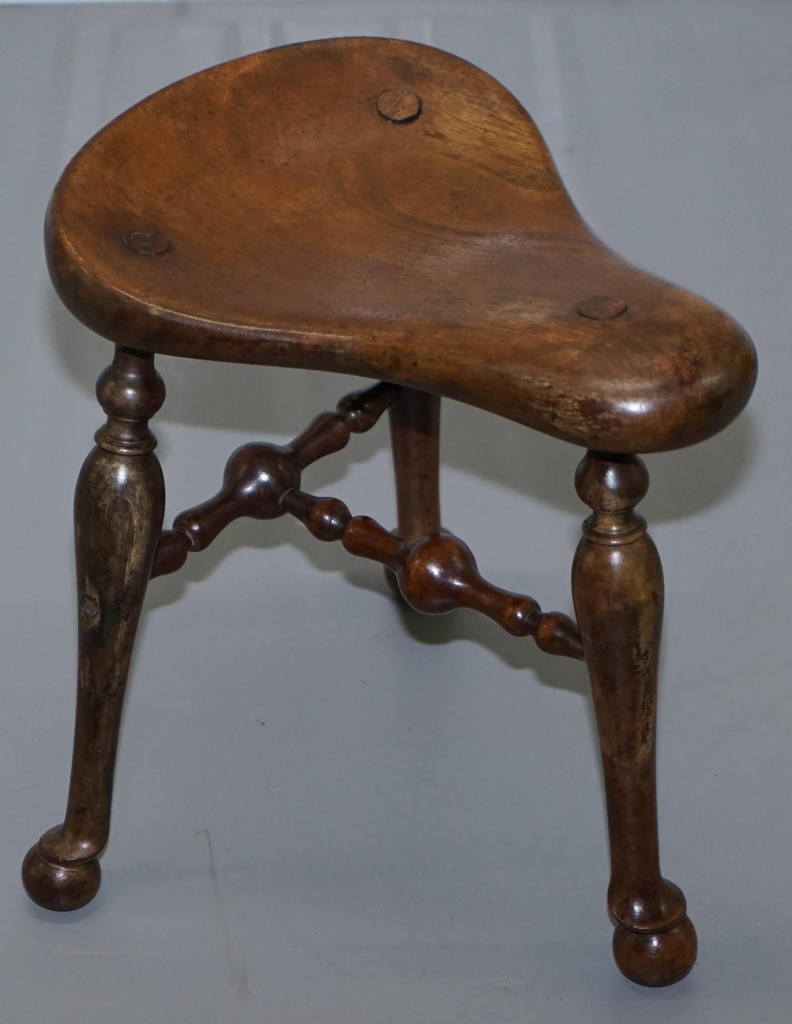 We are delighted to this stunning original Victorian Walnut three legged Saddle stool by Jas Shoolbred

A truly glorious and artistic piece, made by the great Jas Shoolbred, it’s a three-legged stool and is known as a saddle or cock fighting