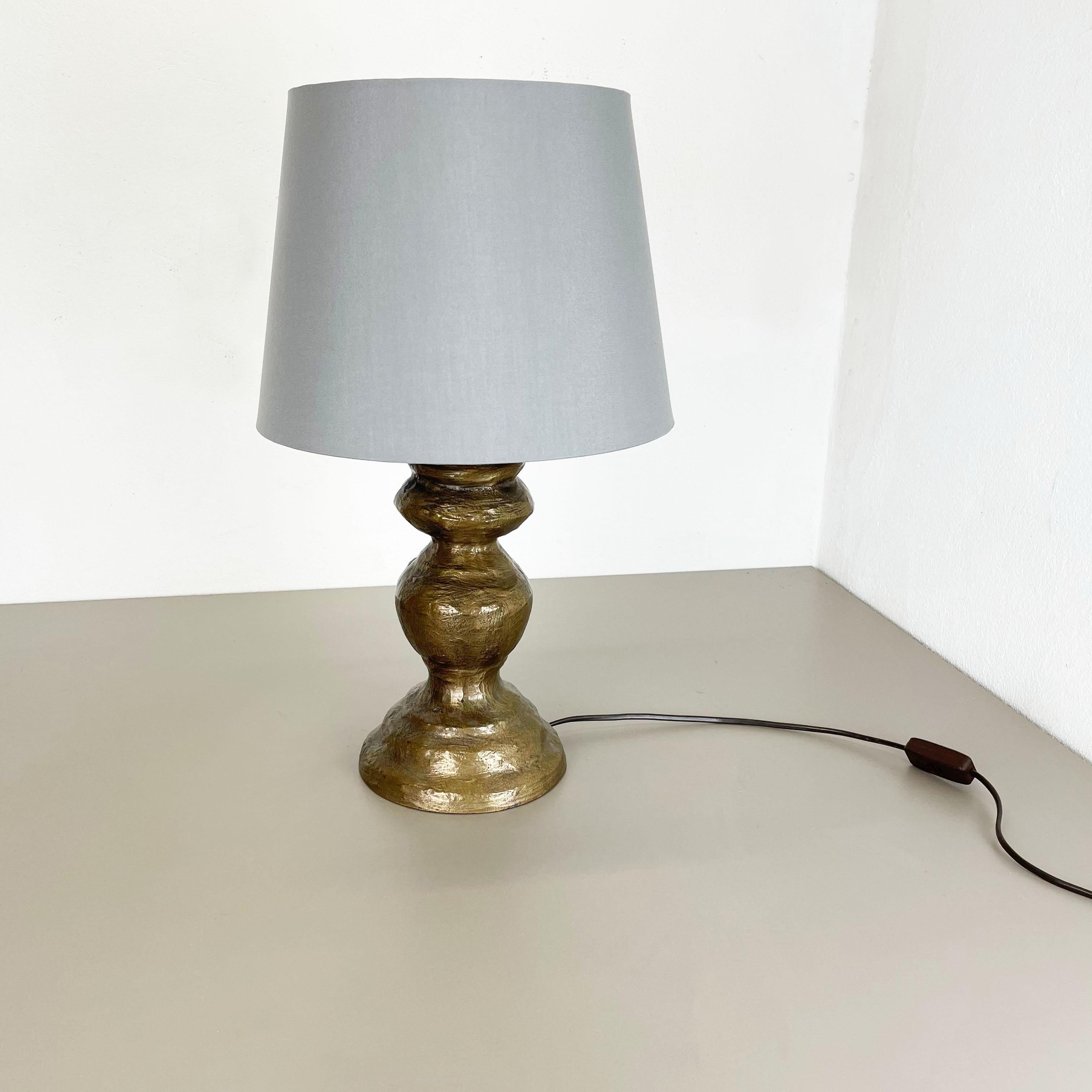 Article:

table light


Origin:

Austria


Age:

1960s


This original vintage table light was designed and produced in the 1960s in Austria. The super rare and Minimalist light stand element has a unique brutalist form and is made of bronze. The