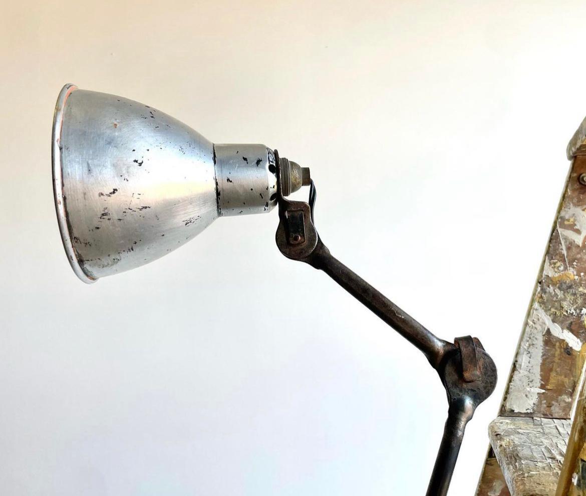 Beautiful original condition. Wonderful patina. 

I believe this lamp once had black paint, but has faded over time and now presents mostly as chrome. The result is a unique example of this lamp. 

More information:

Table lamp designed by