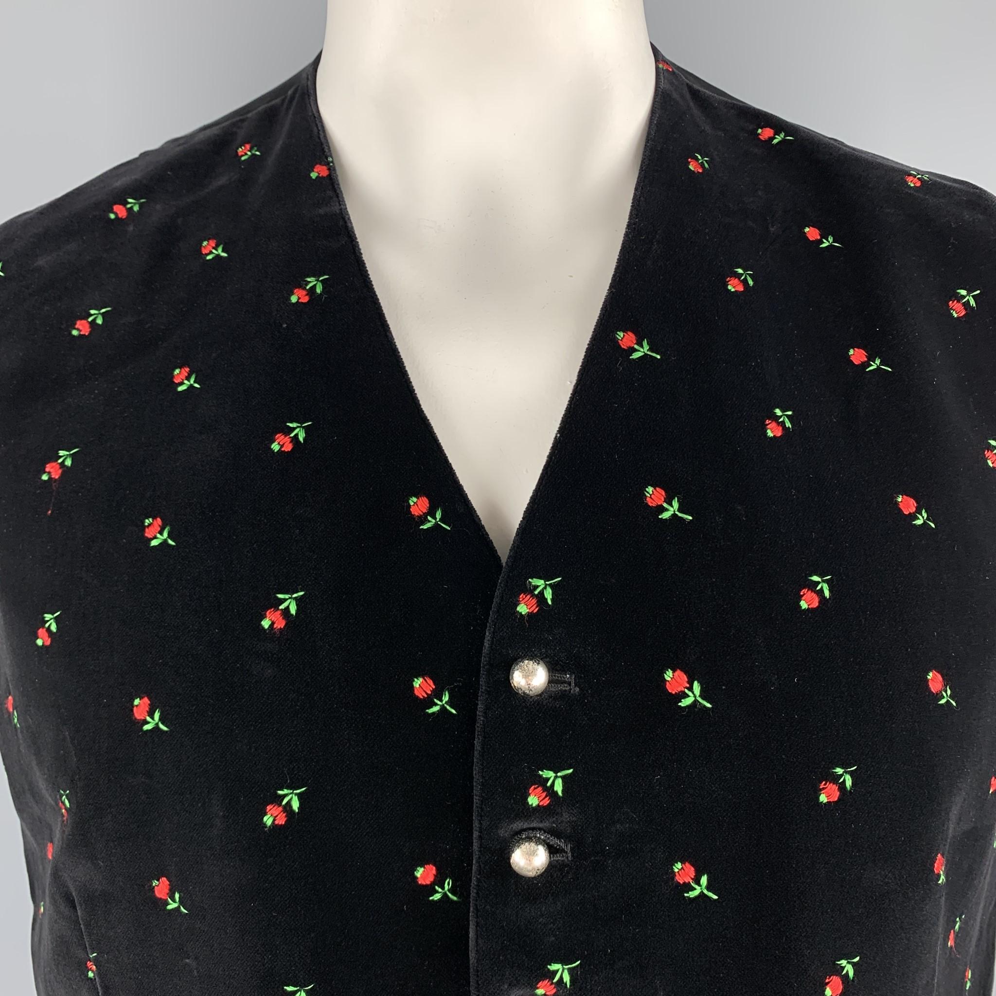 ORIGINAL-LANZ vest comes in black velvet with an all over red and green rosette embroidered pattern, V neck, and antique silver tone metal buttons. Made in Austria.

Excellent Pre-Owned Condition.
Marked: EU 52

Measurements:

Shoulder: 14.5