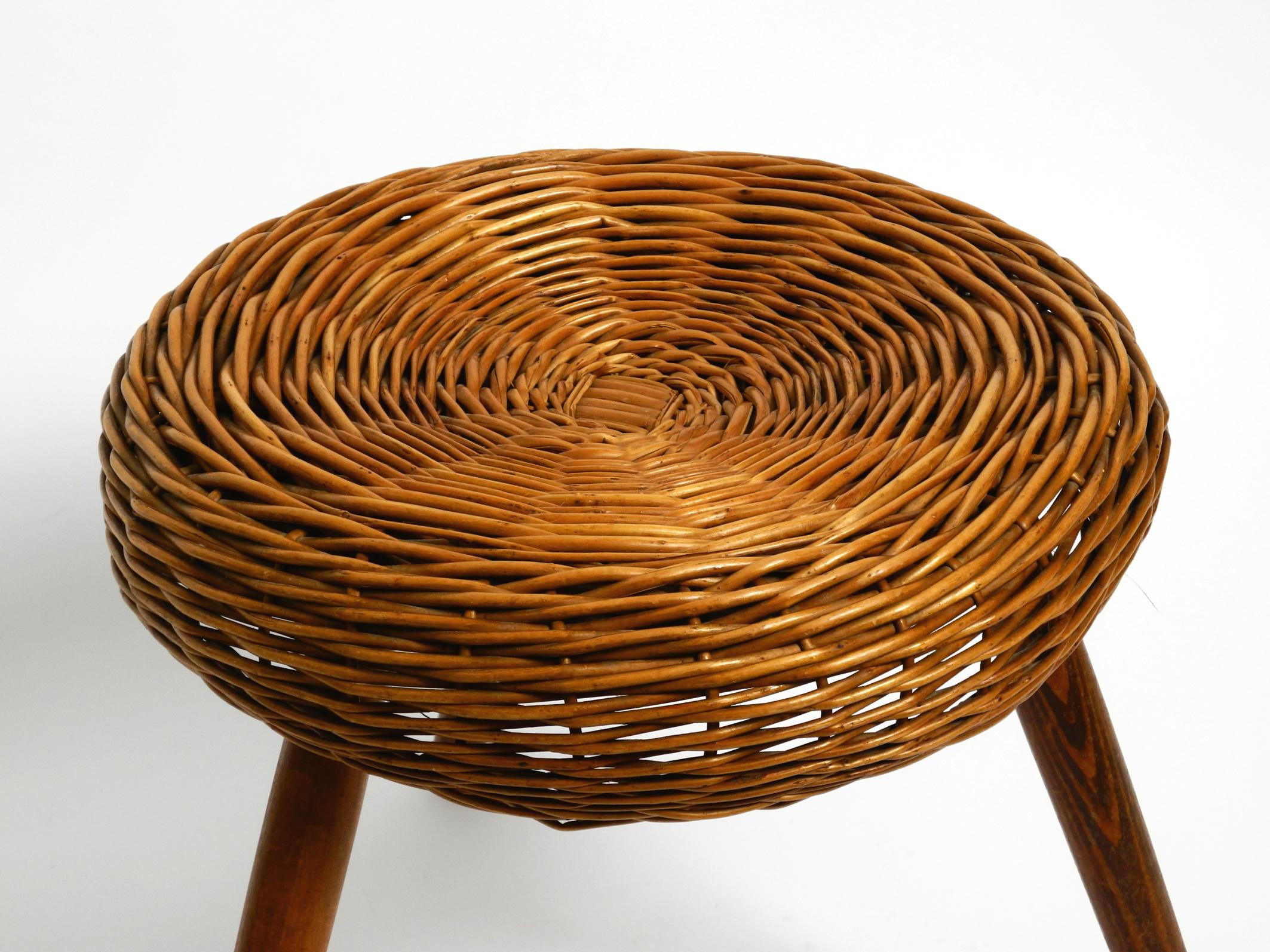 Rattan Original large Mid Century Modern rattan stool with wooden legs by Tony Paul For Sale