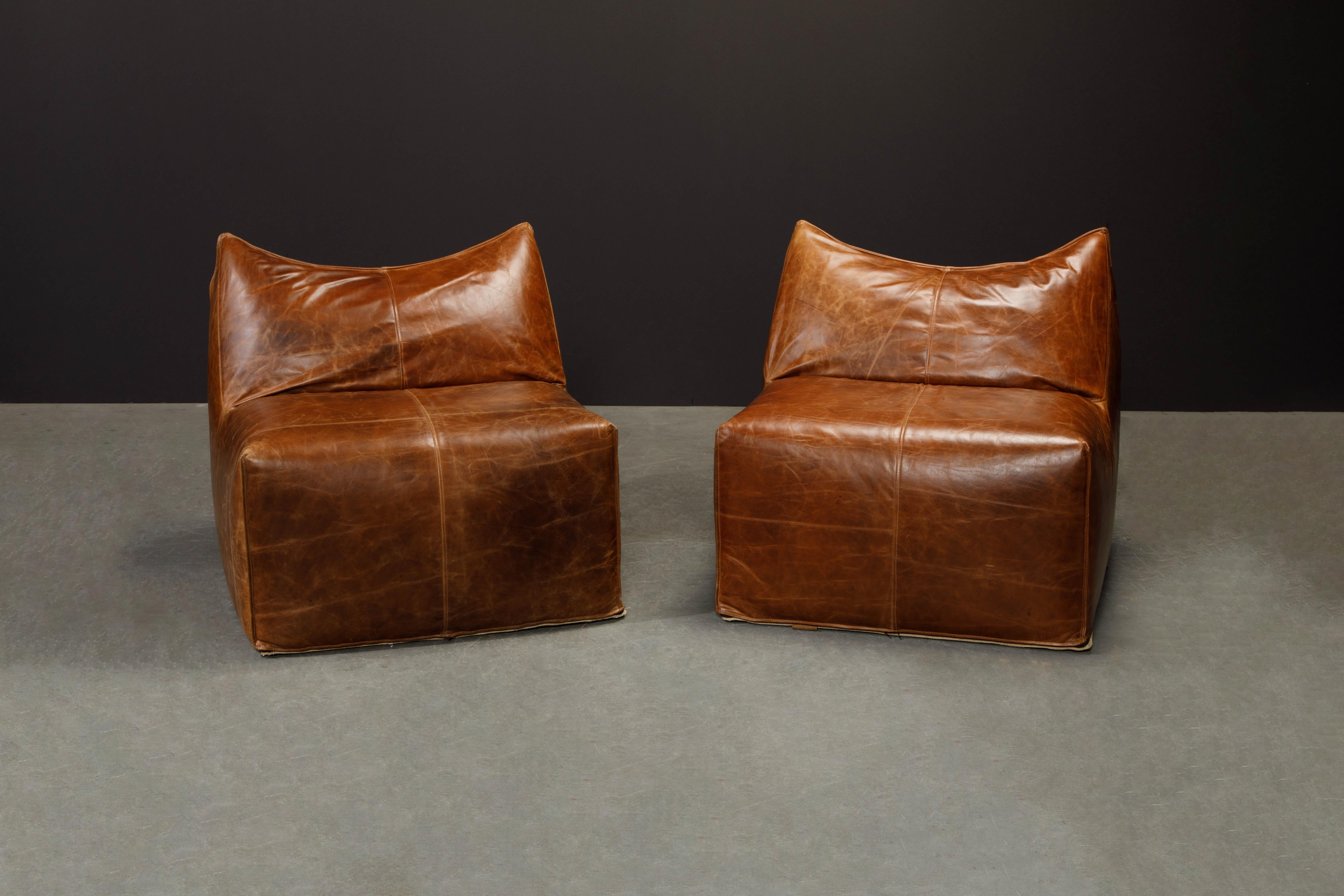 This pair of early year (original) production 'Le Bambole' lounge chairs by Mario Bellini for B&B Italia are signed underneath with B&B stamped canvas fabric and have incredible thick leather hides in a gorgeous deep brown color. The leather is