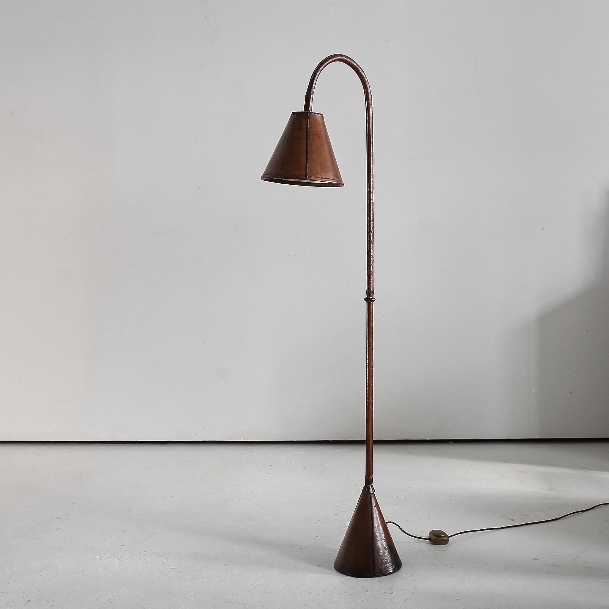 An original C.1950s stitched leather standard lamp by Spanish designers Valenti.

Being an original the lamp has been sympathetically restored over the years and has developed a rich brown patina to the leather.

Recently professionally re-wired/PAT