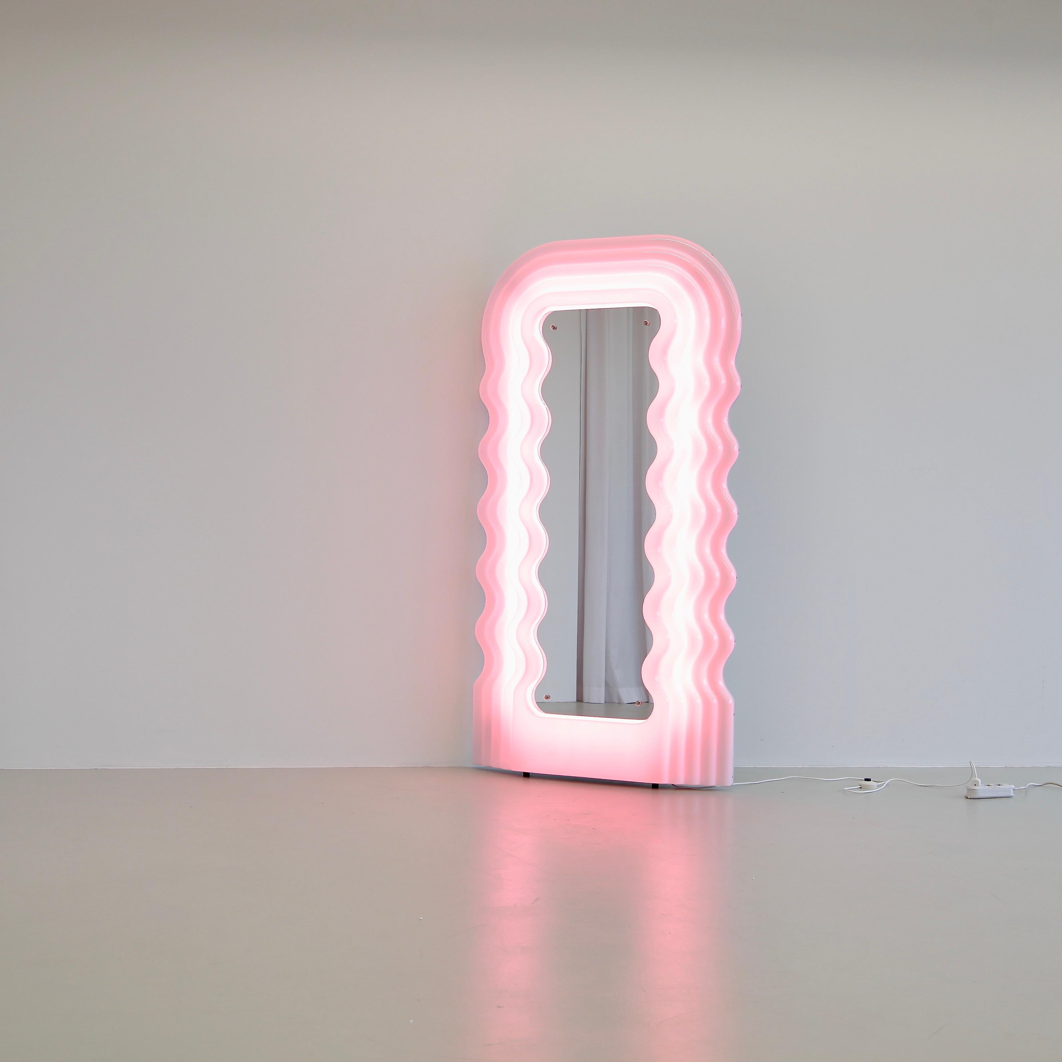 Ultrafragola mirror, designed by Ettore Sottsass in the 1970s.

Original recent production mirror using LED lighting, made of moulded fibreglass with hard-back and shaped mirror. The frame is white, turning pink when the light is switched on.
