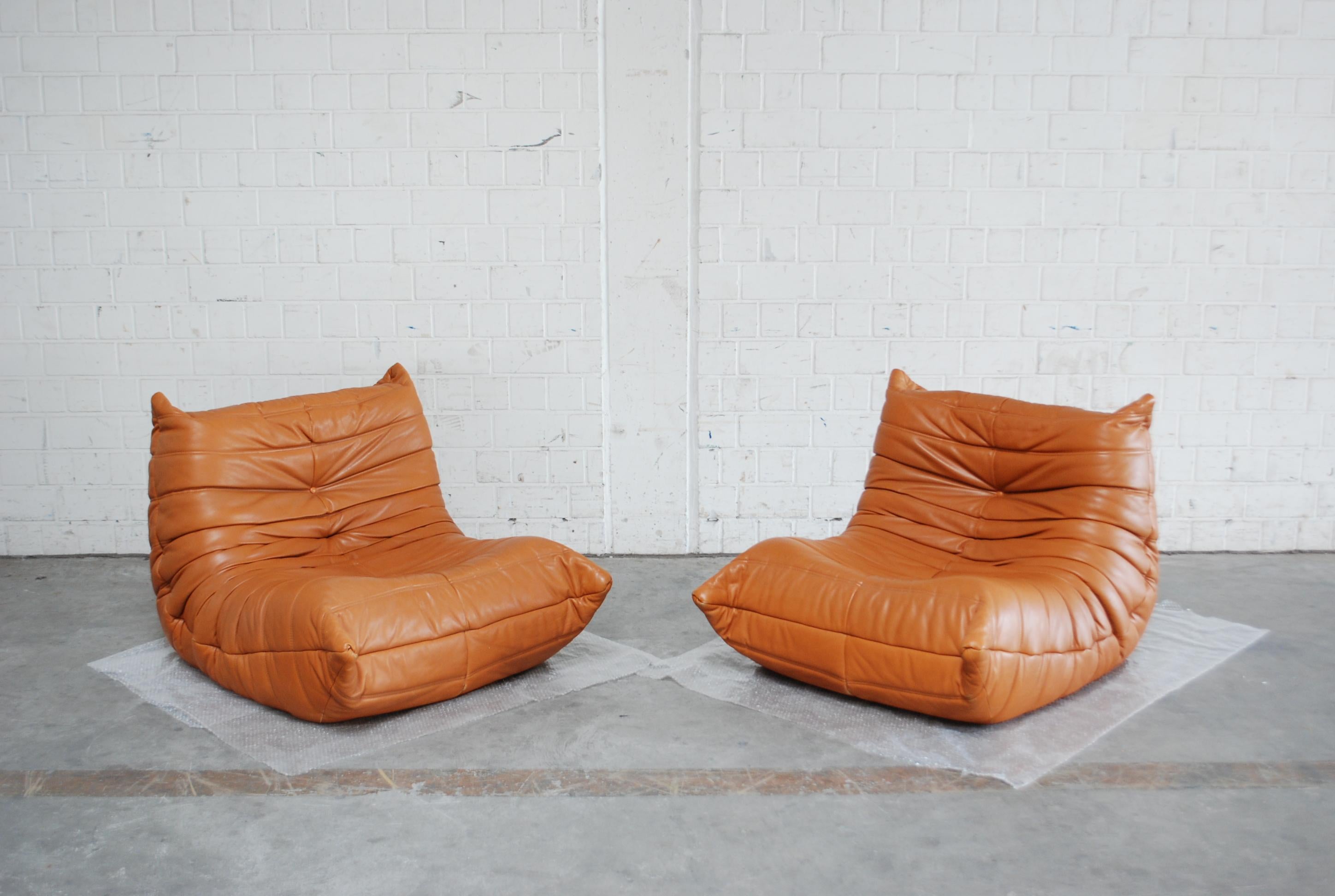 Ligne Roset Model Togo in cognac brandy soft premium aniline leather.
Design by Michel Ducaroy.
Original leather.
From the late 1980s.
In a great condition. Hard to find this beautiful leather in this condition.
Set of 2.
 